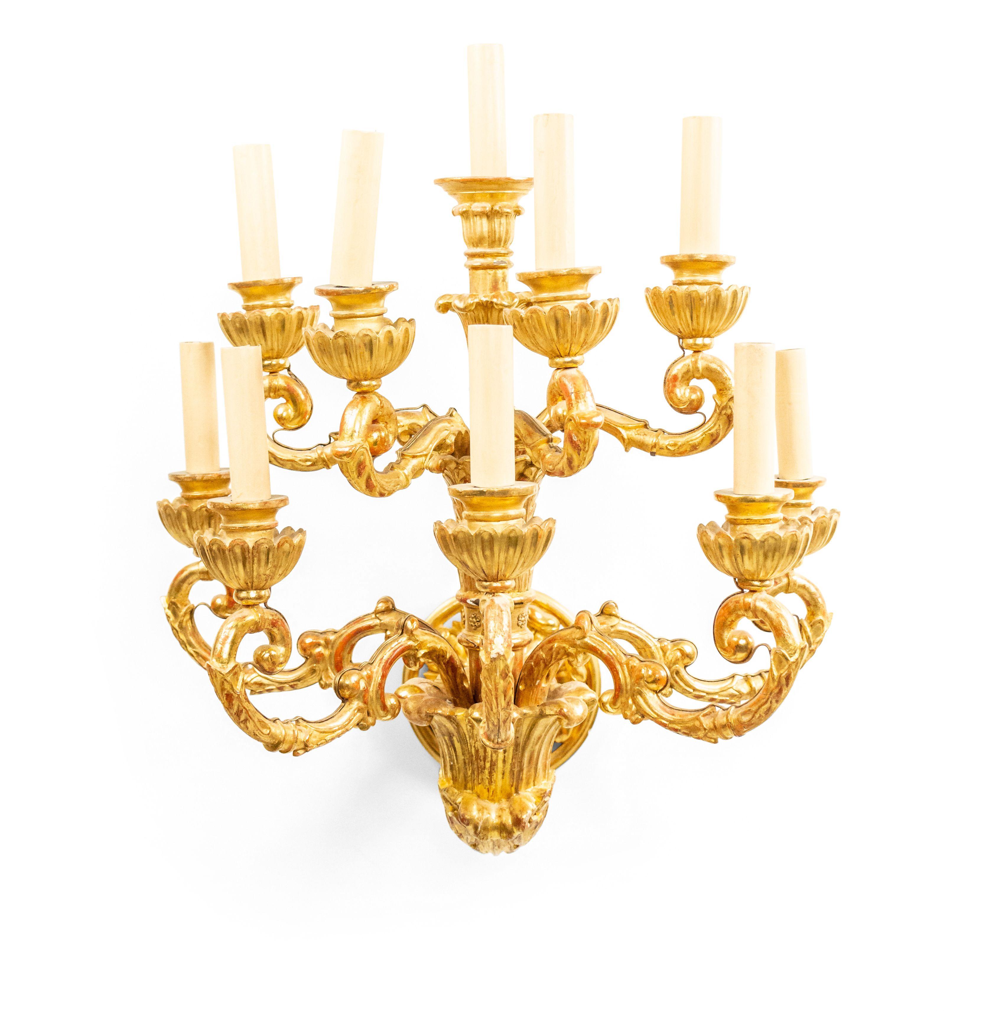 Pair of Italian neoclassic 18th century gilt wall sconces with 10 (3-tier) scroll form arms with acanthus leaf carving emanating from a carved wall bracket.