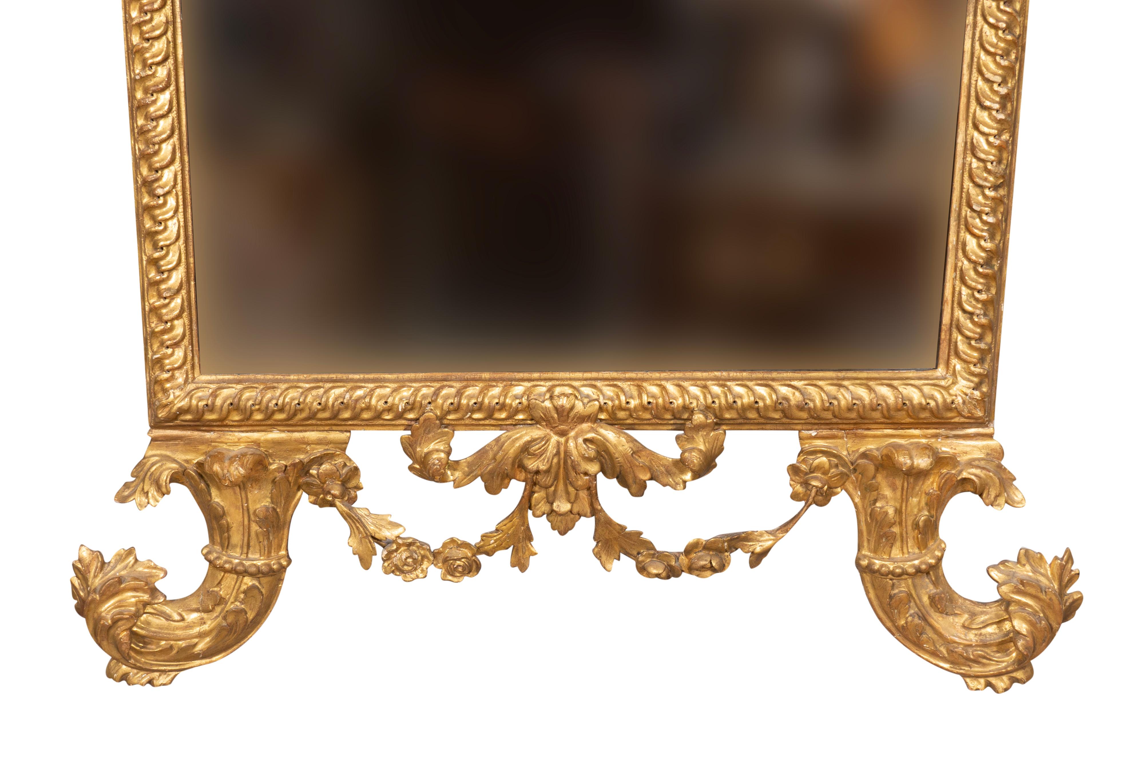 With original gilding. The top decorated with a pair of dolphins. Overall beautifully carved and gilded guilloche carved frame. From the estate of Dariel Firestone. 