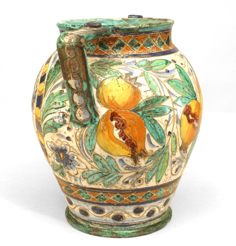 Italian neo-classic antique Majolica vase with side handles and decorated with blue, yellow, and green flowers, fruit and bird.
    