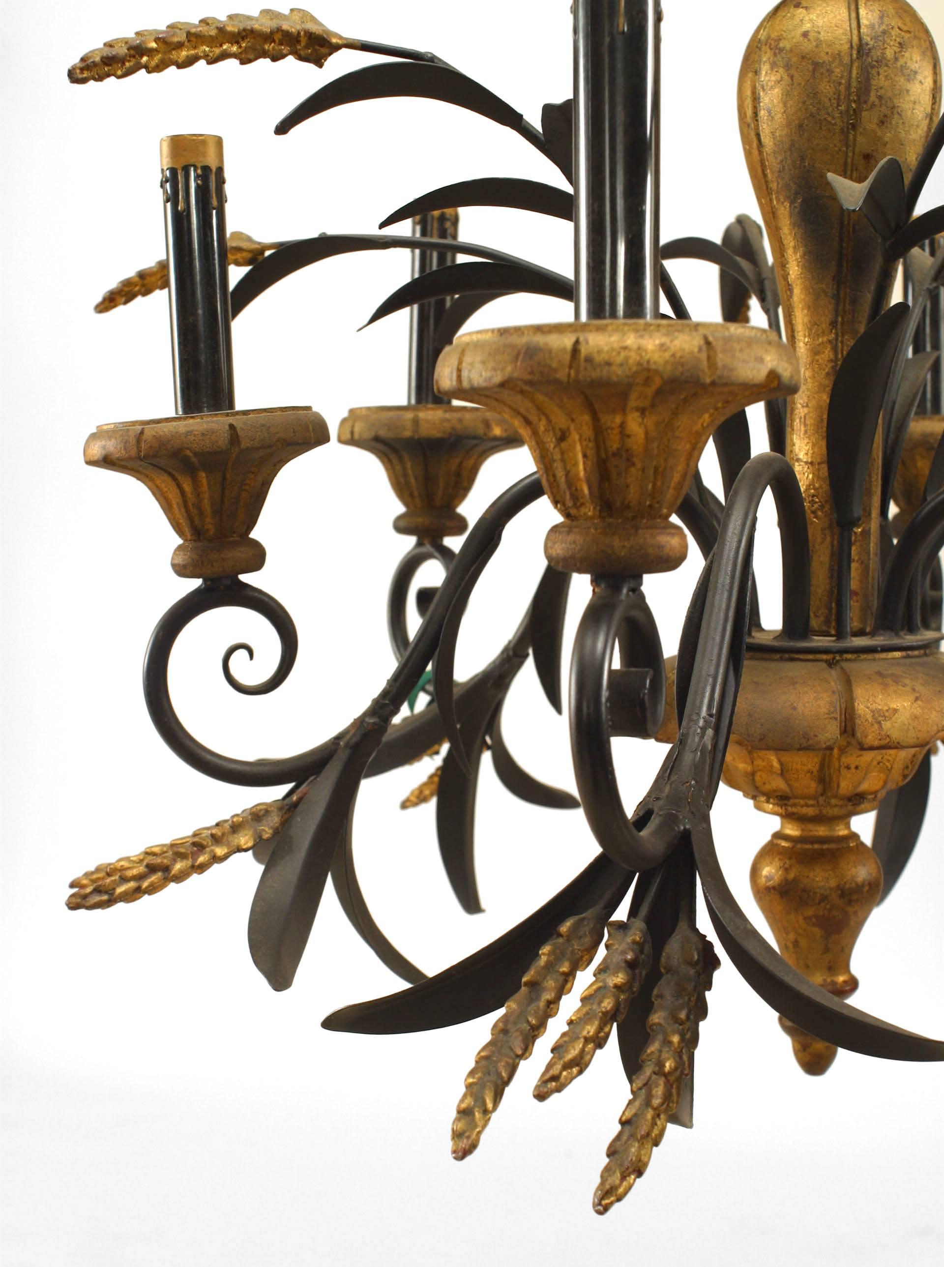 Italian neoclassic style, 1940s gilt carved wood and ebonized tole six scroll arm chandelier decorated with spays of carved wheat.
         
