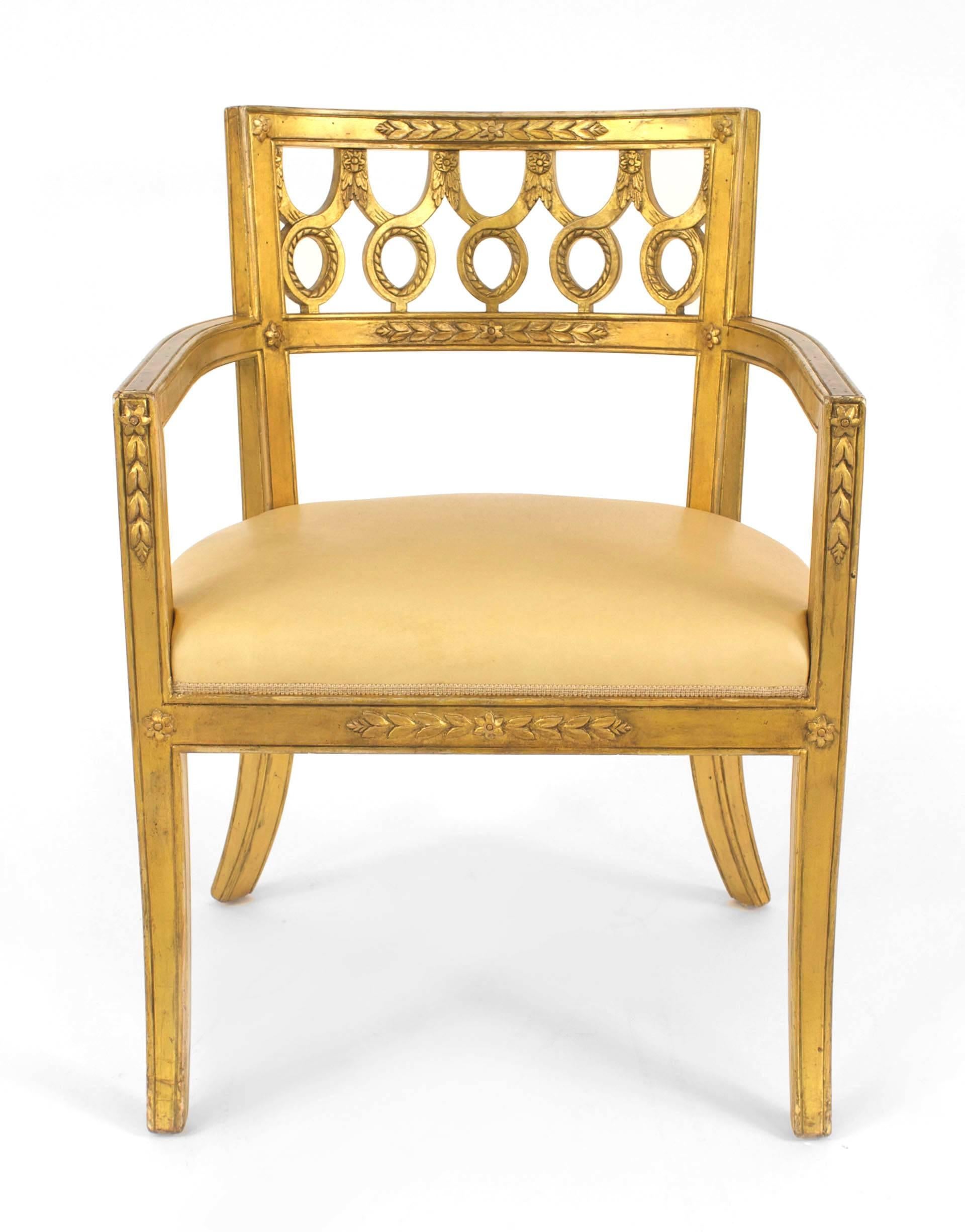 Set of 12 Italian Neoclassic-style gilt wood arm chairs with a round back with a carved circle design & upholstered tan leather seats.
