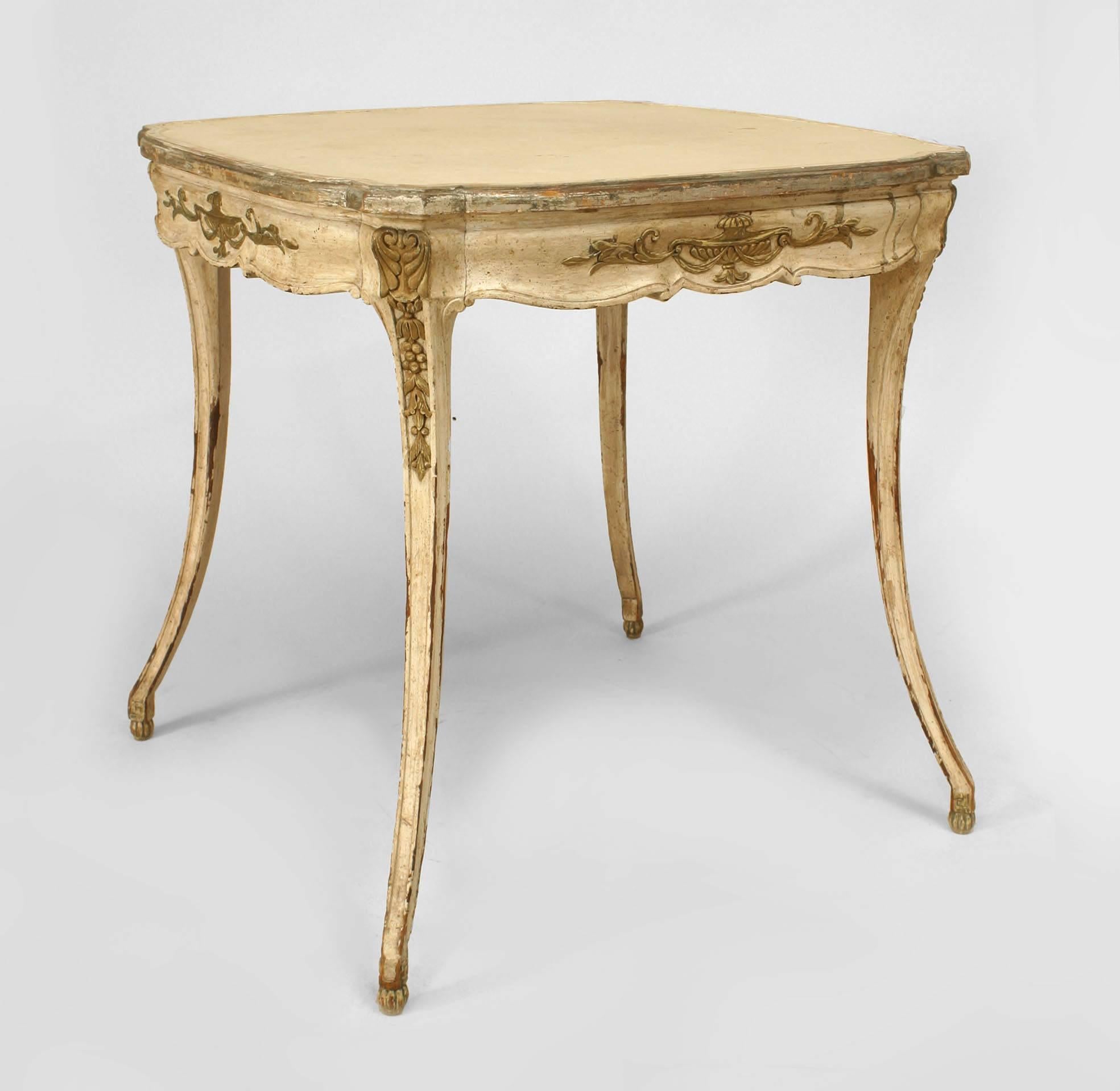 Italian Neoclassic style square end table painted white and decorated with silver gilt carvings on its apron and four splayed legs.