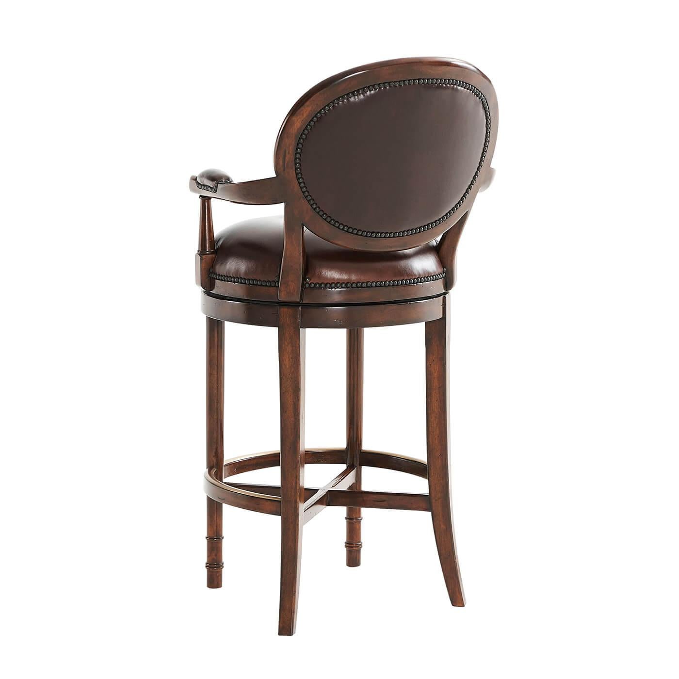 An Italian neoclassic bar stool, with a leather upholstered oval padded back and circular swivel seat, on turned legs, joined by an 
