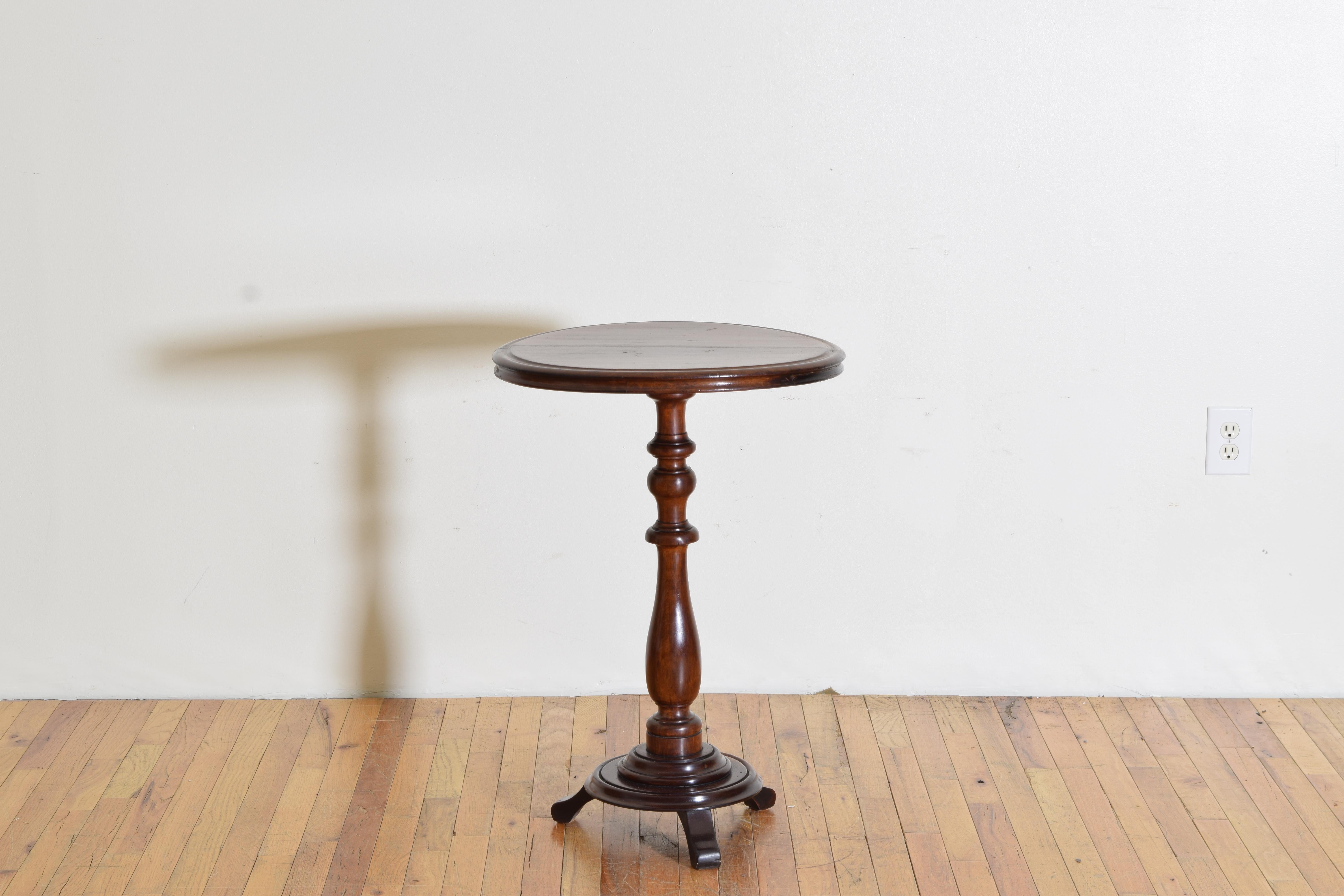 Having a circular top with unique molded edge atop a turned standard on a graduated plinth-form base, the circular base issuing three shaped feet
