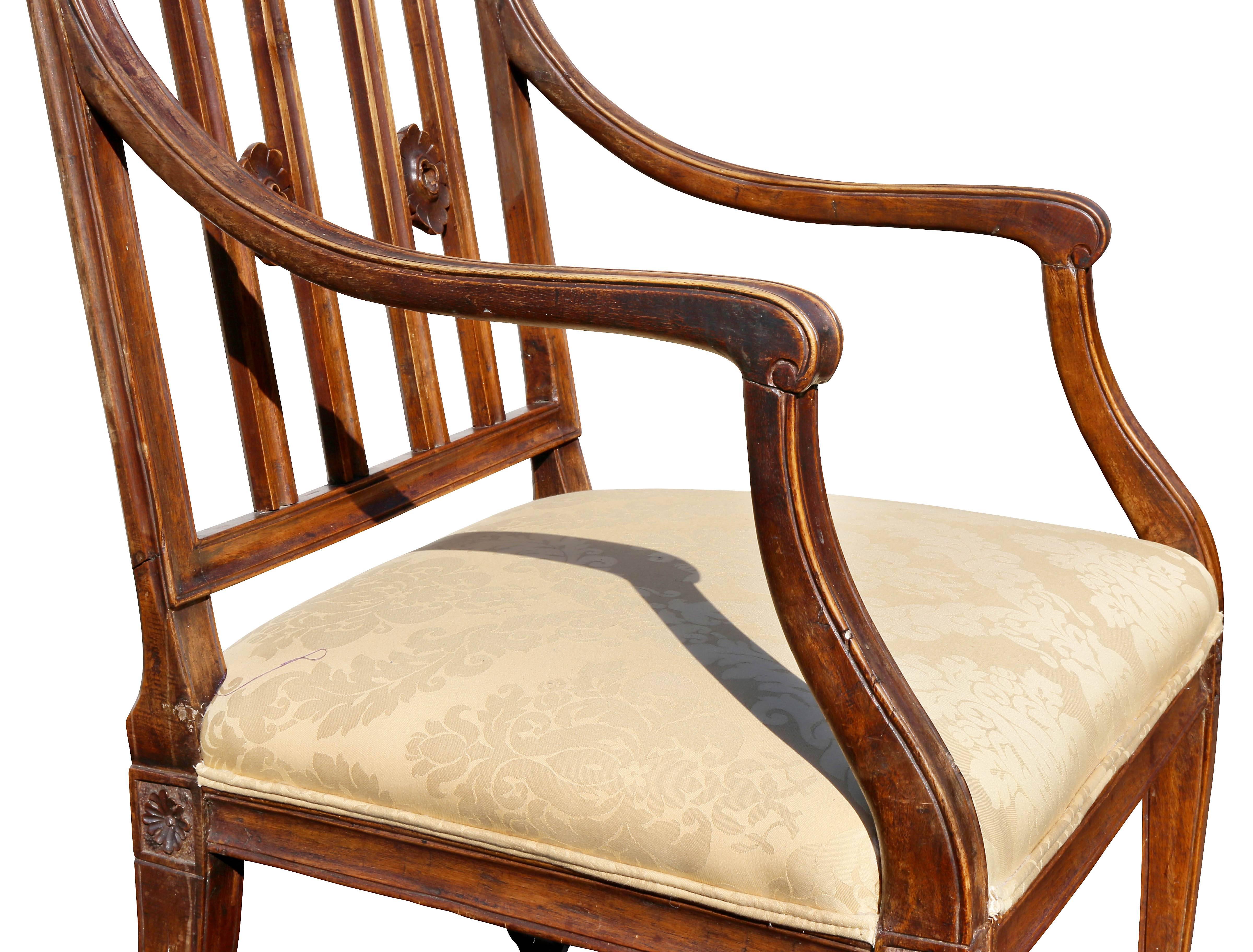 With straight crest rail over two pairs of vertical splats with carved rings over an upholstered seat raised on square tapered legs headed by paterae.