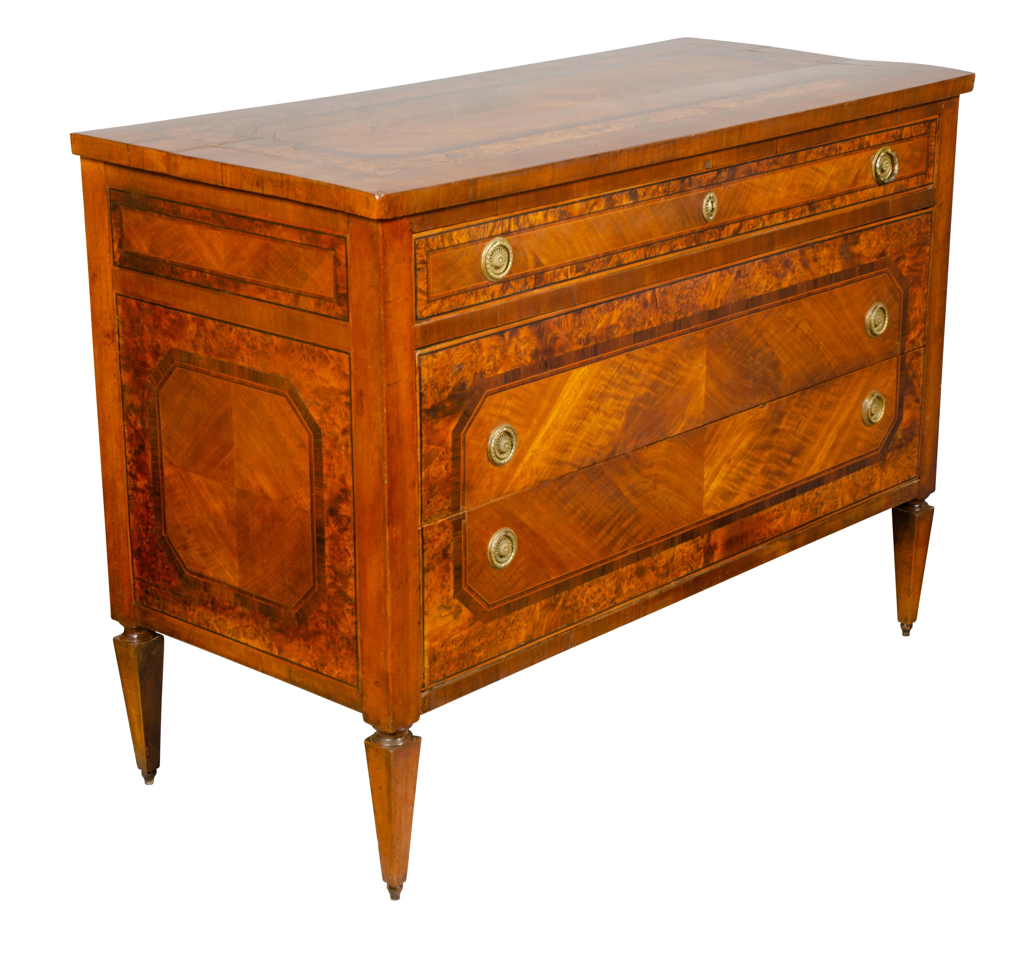 Rectangular top with burl banding over a drawer and two lower drawers sans traverse, raised on square tapered legs.