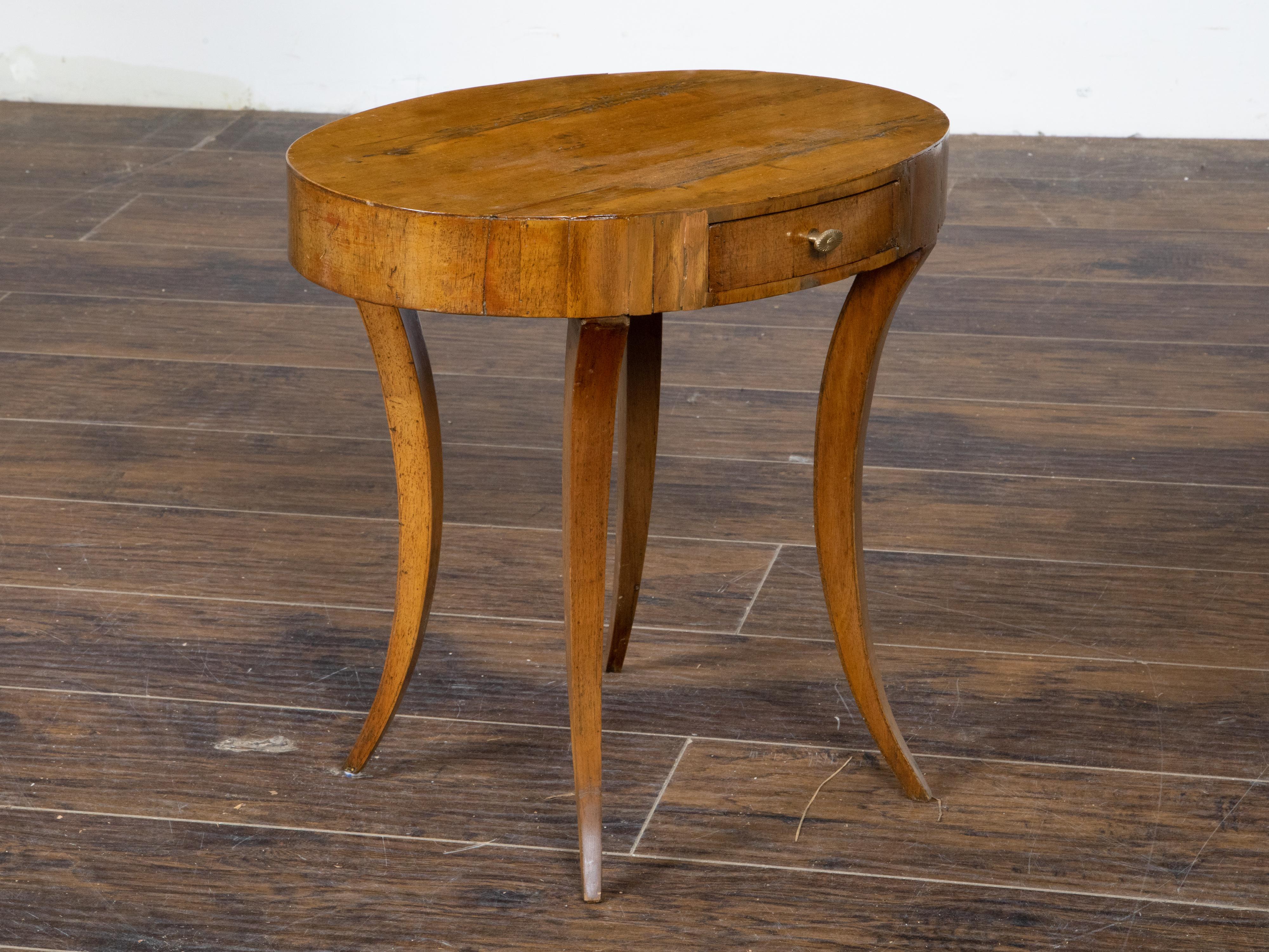 Brass Italian Neoclassical 1810s Walnut Table with Oval Top, Drawer and Saber Legs For Sale