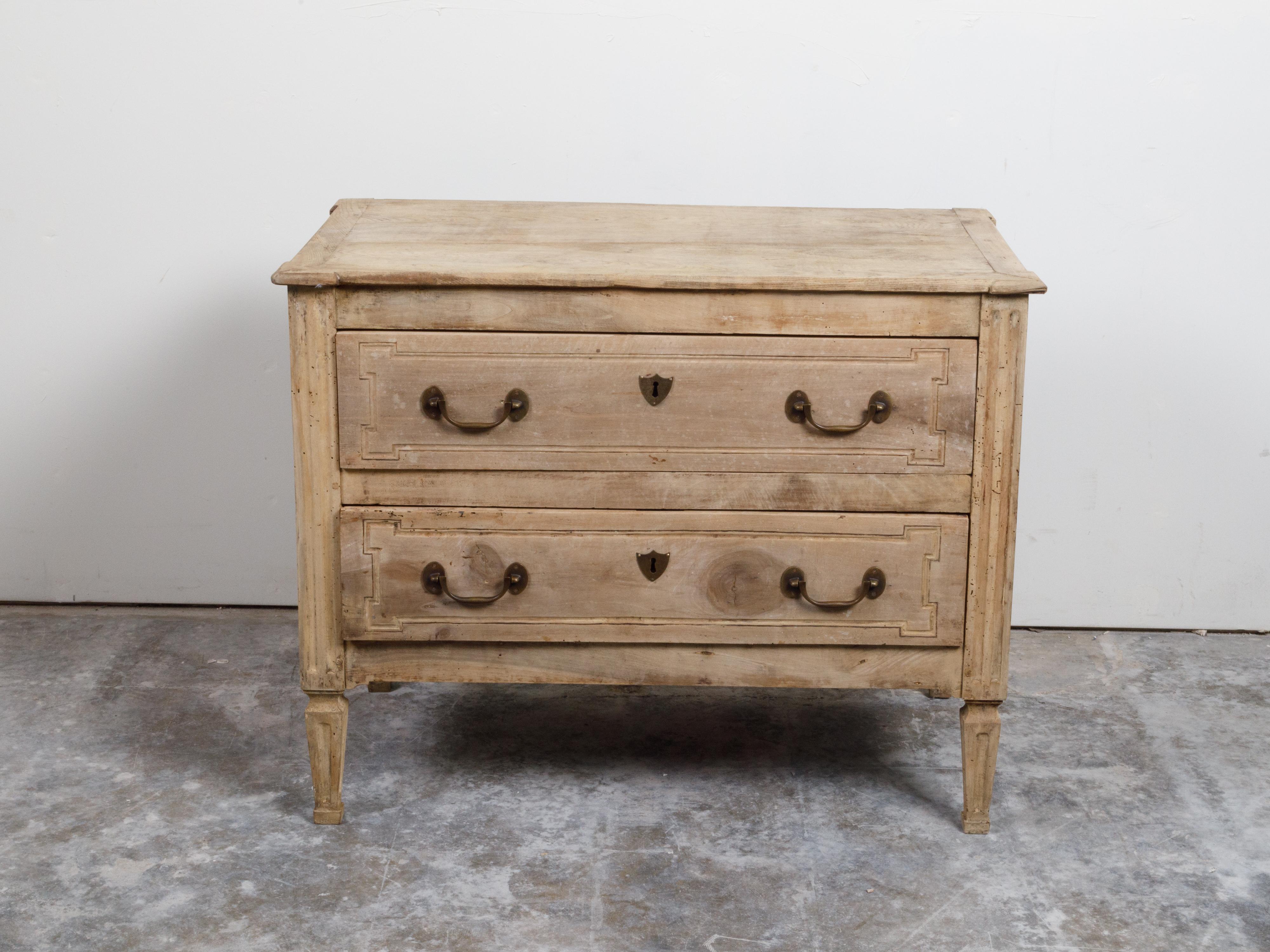 An Italian neoclassical period bleached walnut commode from the 18th century, with two drawers, fluted side posts and tapered legs. Created in Italy during the 18th century, this Neoclassical bleached walnut commode features a rectangular top