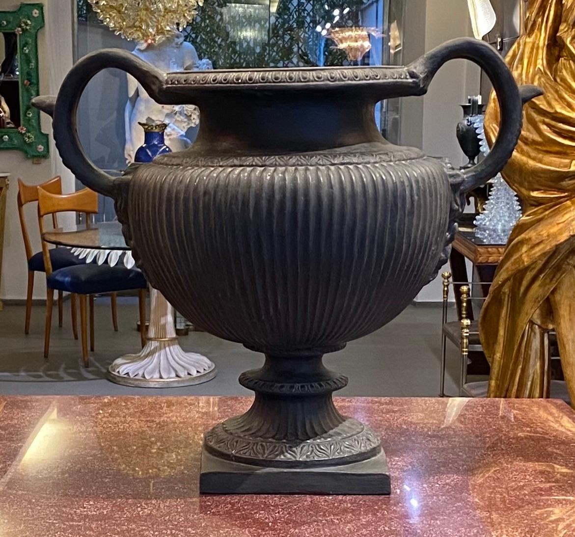Elegant Italian 19th century neoclassical black painted terracotta vase after the original Roman marble vase. 
Bordered center body decorated with stylized bands of palmettes. 
Similar examples are present in the Capitolium Museum in