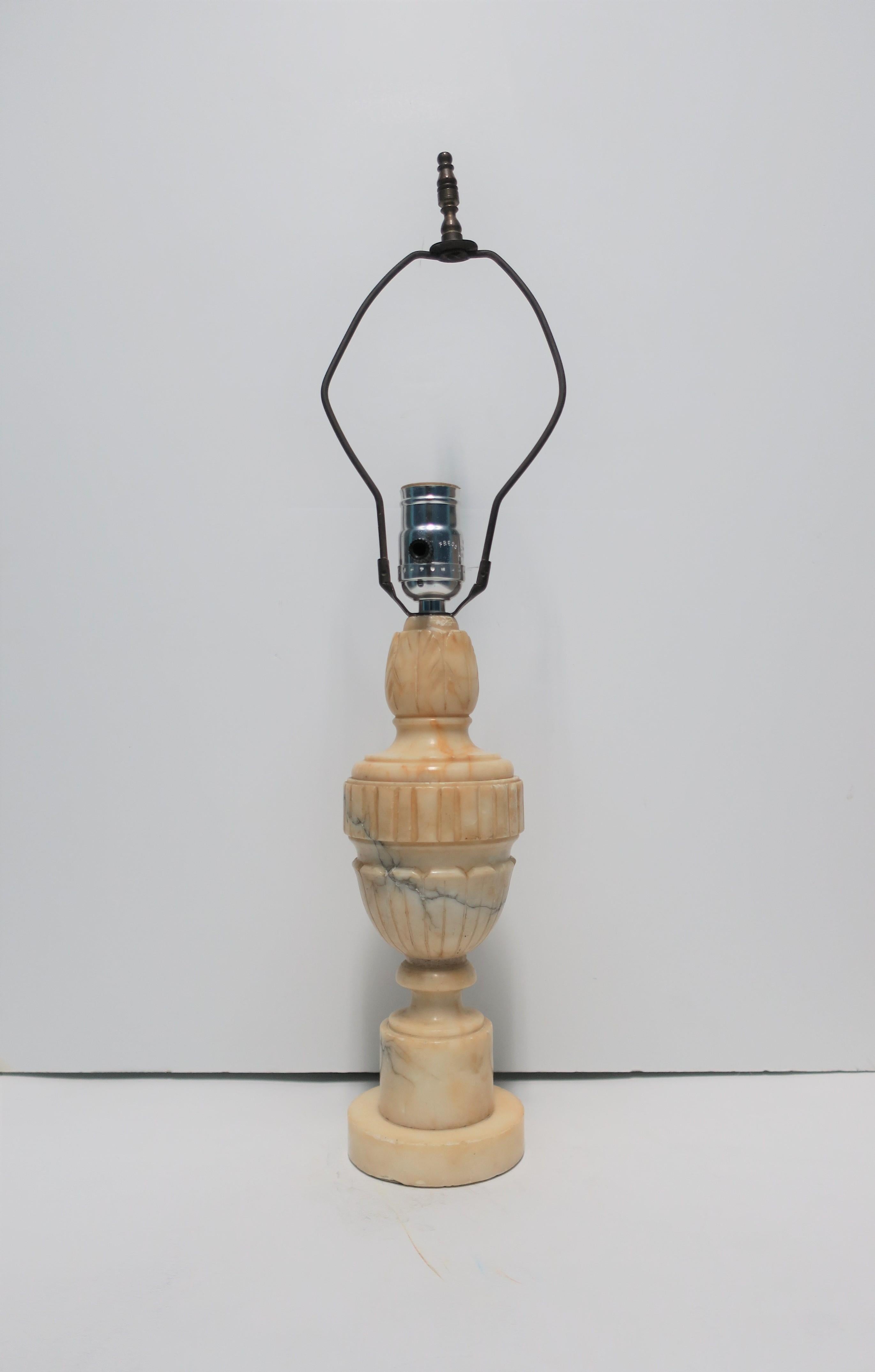A beautiful, relatively small, Neoclassical style Italian alabaster marble 'Urn' form desk or table lamp, circa early 20th century, Italy. Alabaster marble is a cream and butter hue with dark grey veining. Lamp has beautiful carved details at top