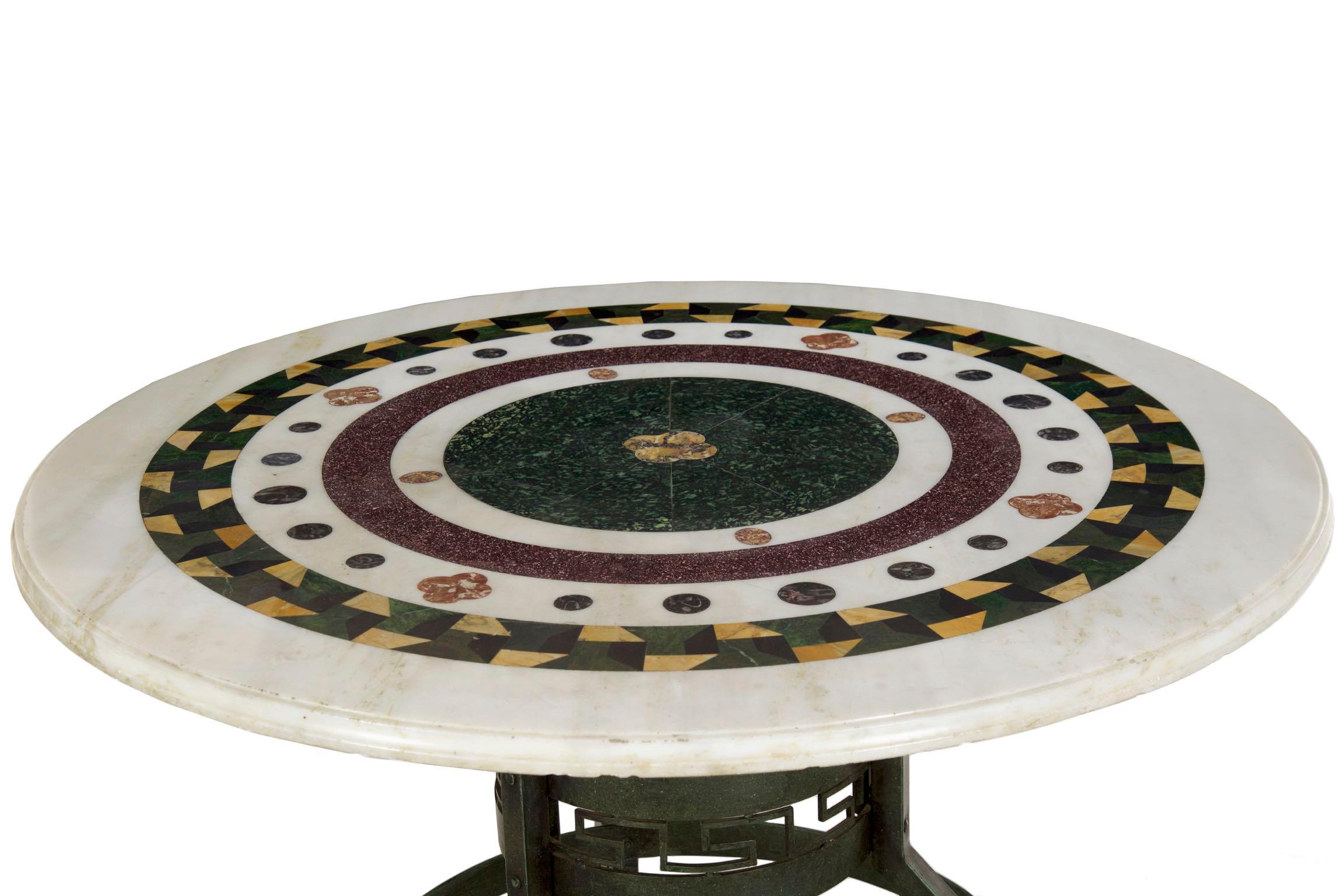 An exceptional center table with a striking blend of the modern and historical, the angular Greek-key form bronze base was likely crafted during the first half of the 20th century and is finished in an attractive green Verdigris patina. It supports