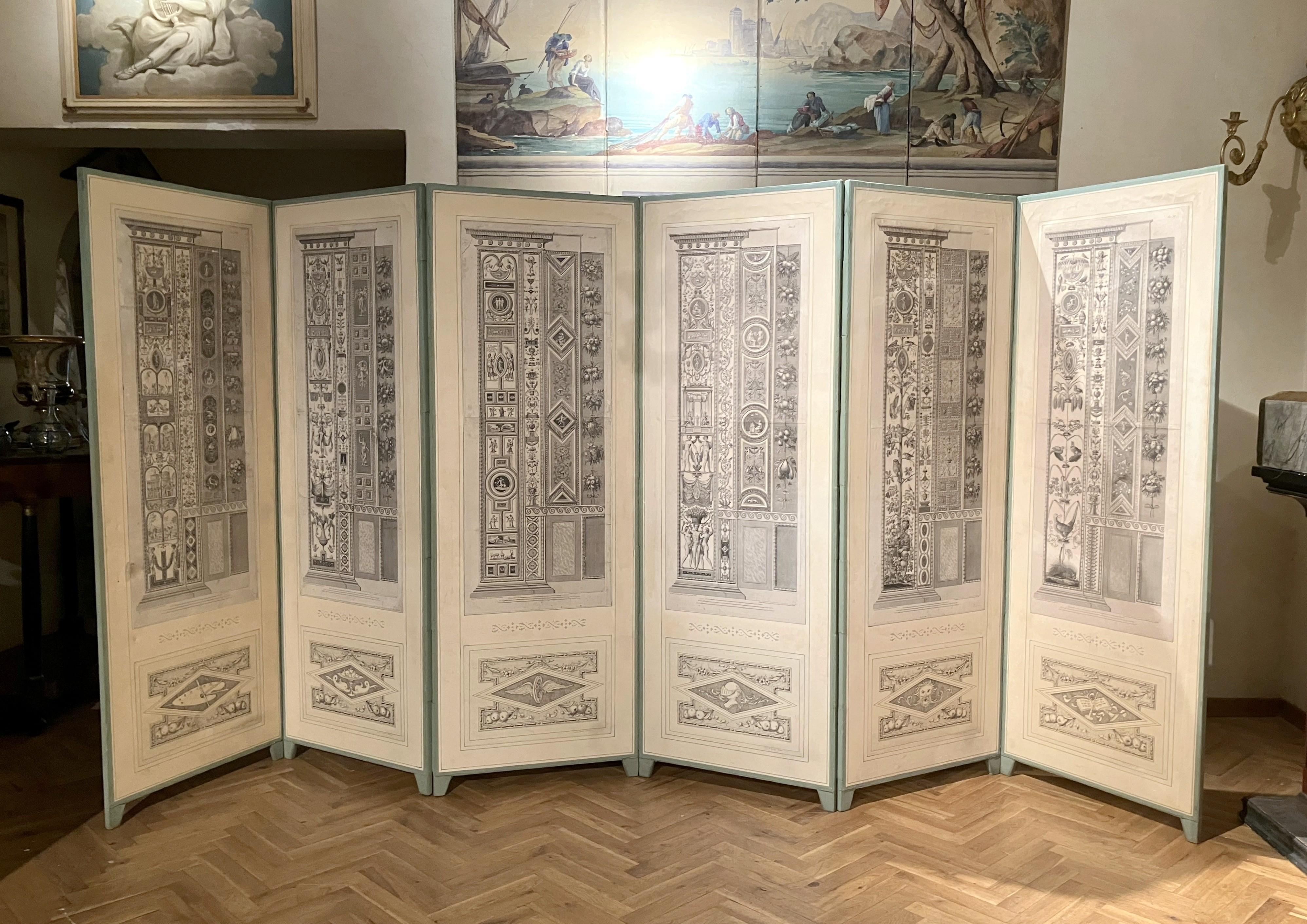 This Italian 18th century Neoclassical period folding screen consists of six panels with antiques etched and engraved copperplates on paper reproducing the frecoes painted by Raffaello Sanzio in the Vatican, known as ' The Vatican Loggia'. 
Each