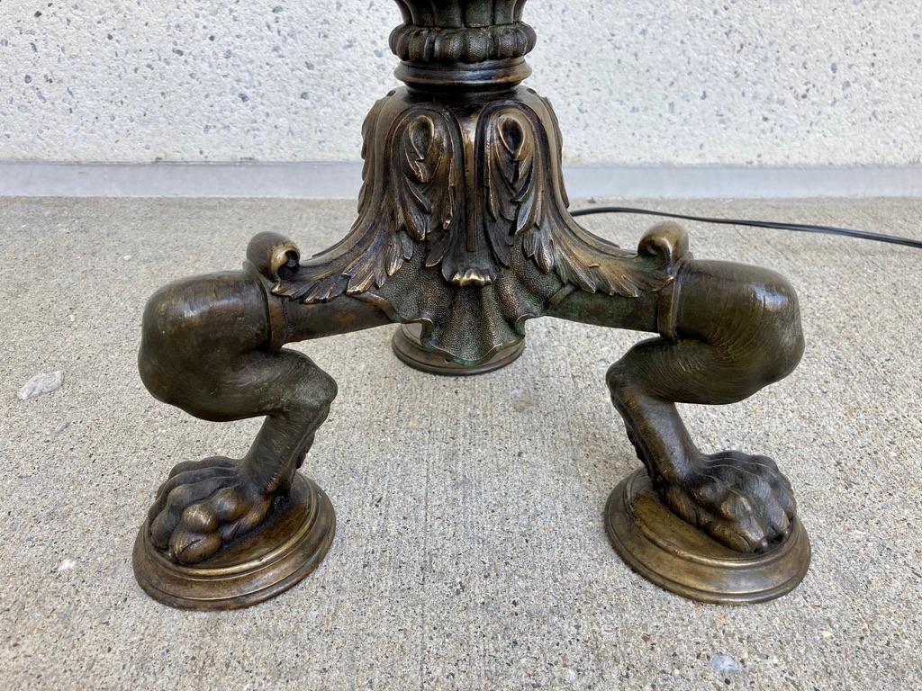 Beautifully cast Italian neoclassical style bronze floor lamp modeled after an original excavated at Pompeii or Herculaneum. With acanthus leaf decoration above and below the reeded shaft and expertly chased and detailed tripod legs ending in animal