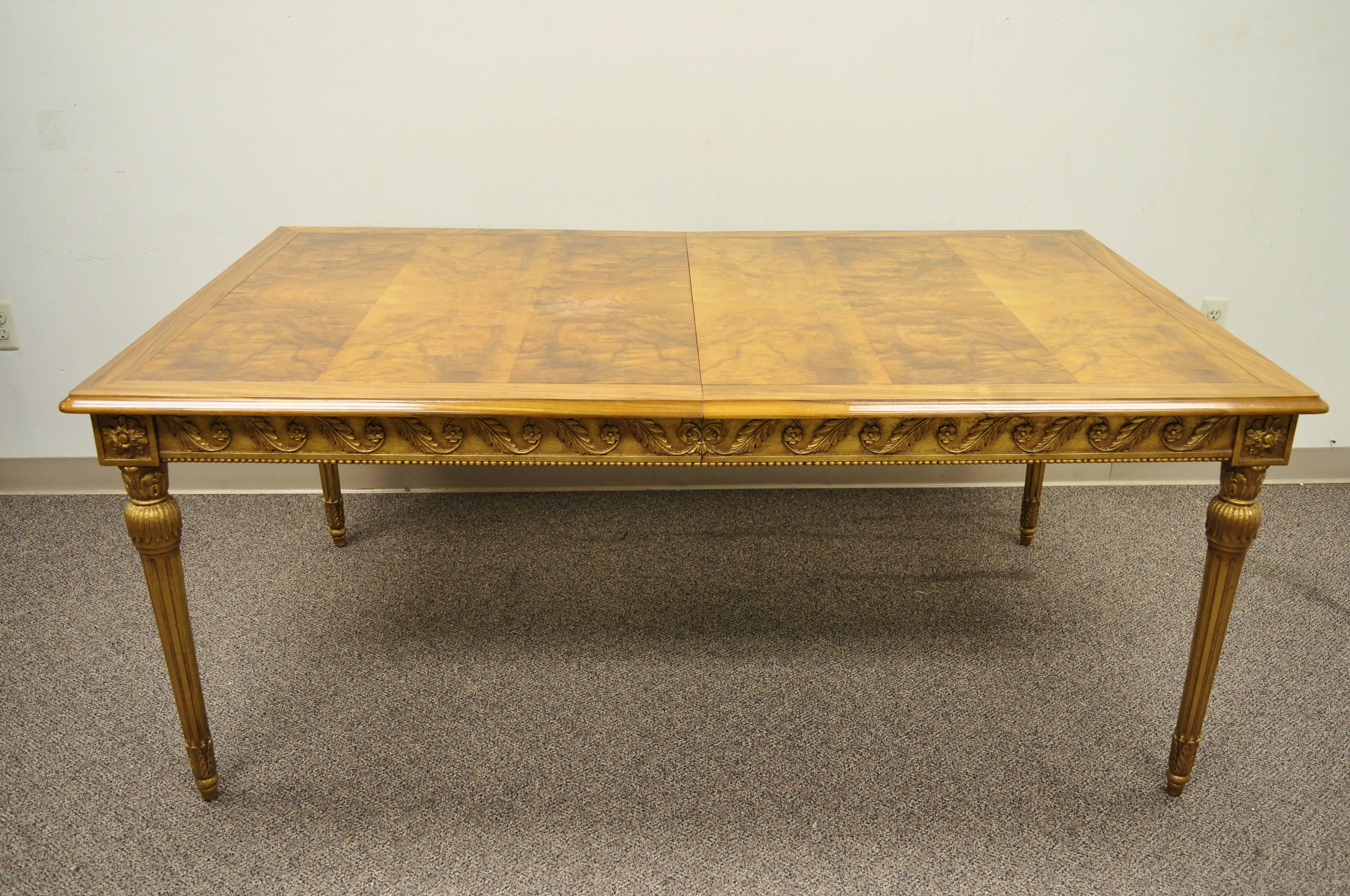 French Louis XVI / Italian neoclassical style burl walnut gold giltwood rectangular dining table. Item features (2) 12