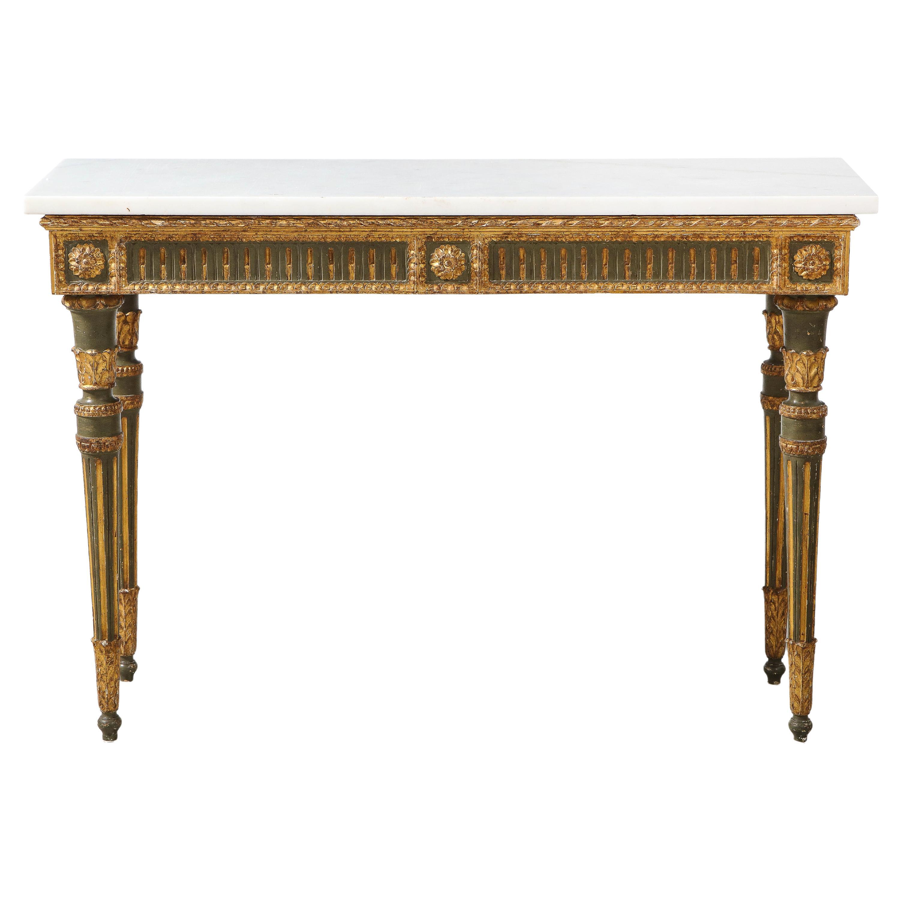 An exquisite and elegant Florentine 18th century Louis XVI period carved, painted and gilded wood neoclassical console table, with Carrara white marble top. The rectangular frieze is decorated on the front and sides with carved and gilded flutes, on