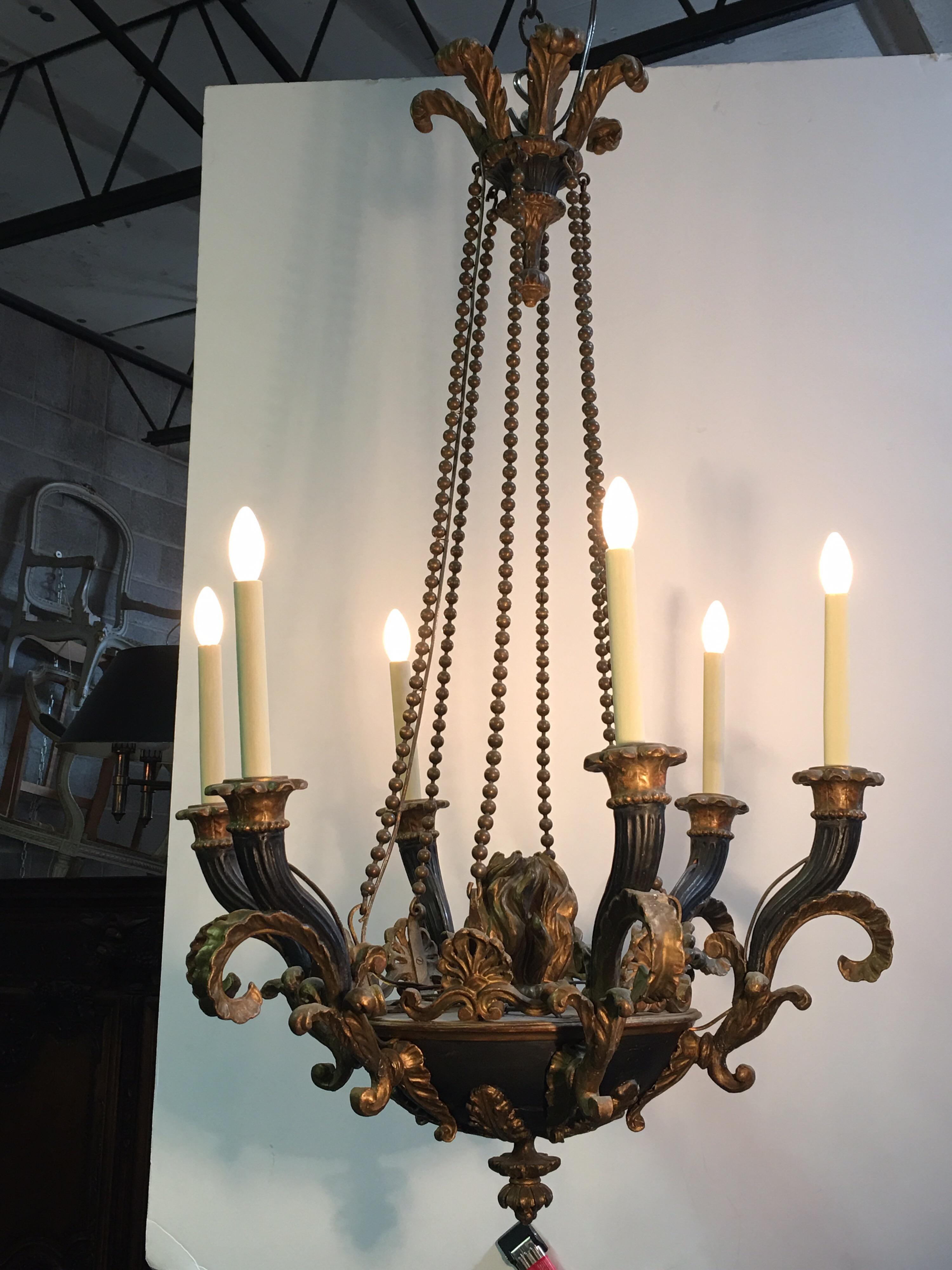 Italian Neoclassical carved wood chandelier with a painted and parcel gilt finish and bronze roping.