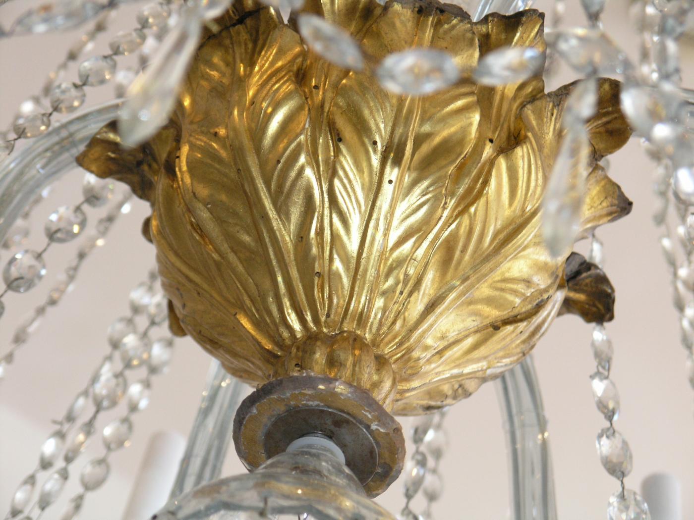 Chamfered crystal columnar standard above a giltwood urn issuing scrolled candle arms.