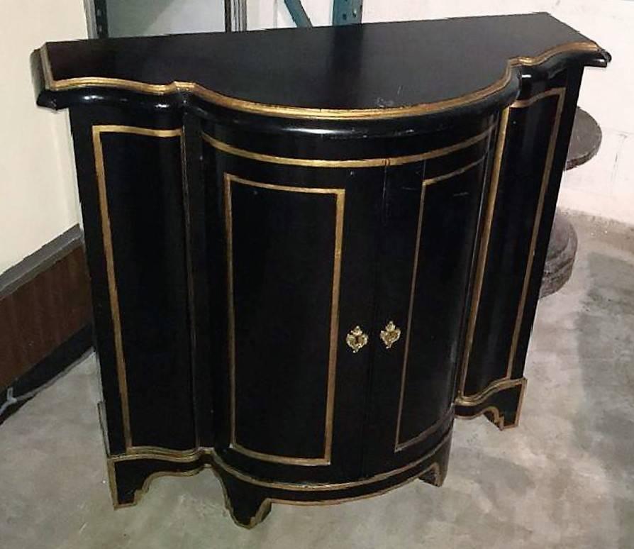 Great look!! Italian neoclassical style black lacquered and parcel-gilt shaped front console cabinet. 

Beautifully contoured.

circa 1930.