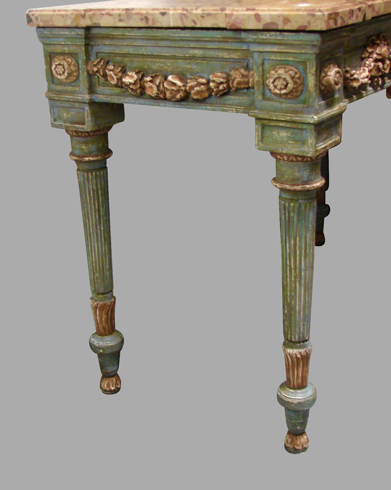 A pretty Italian neoclassical cream and grey painted console table, the Breche d'Alep marble top supported by a highly carved painted base with a central cartouche and floral swags, the sides similarly executed, supported on round tapered reeded