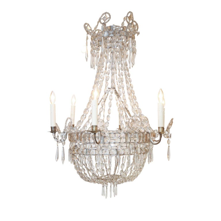 Italian neoclassical crystal chandelier (circa 1890-1910) with six undulating metal arms. Decorated in crystal and glass prisms and pendants. Newly-wired for use within the USA. Includes chain and a canopy.