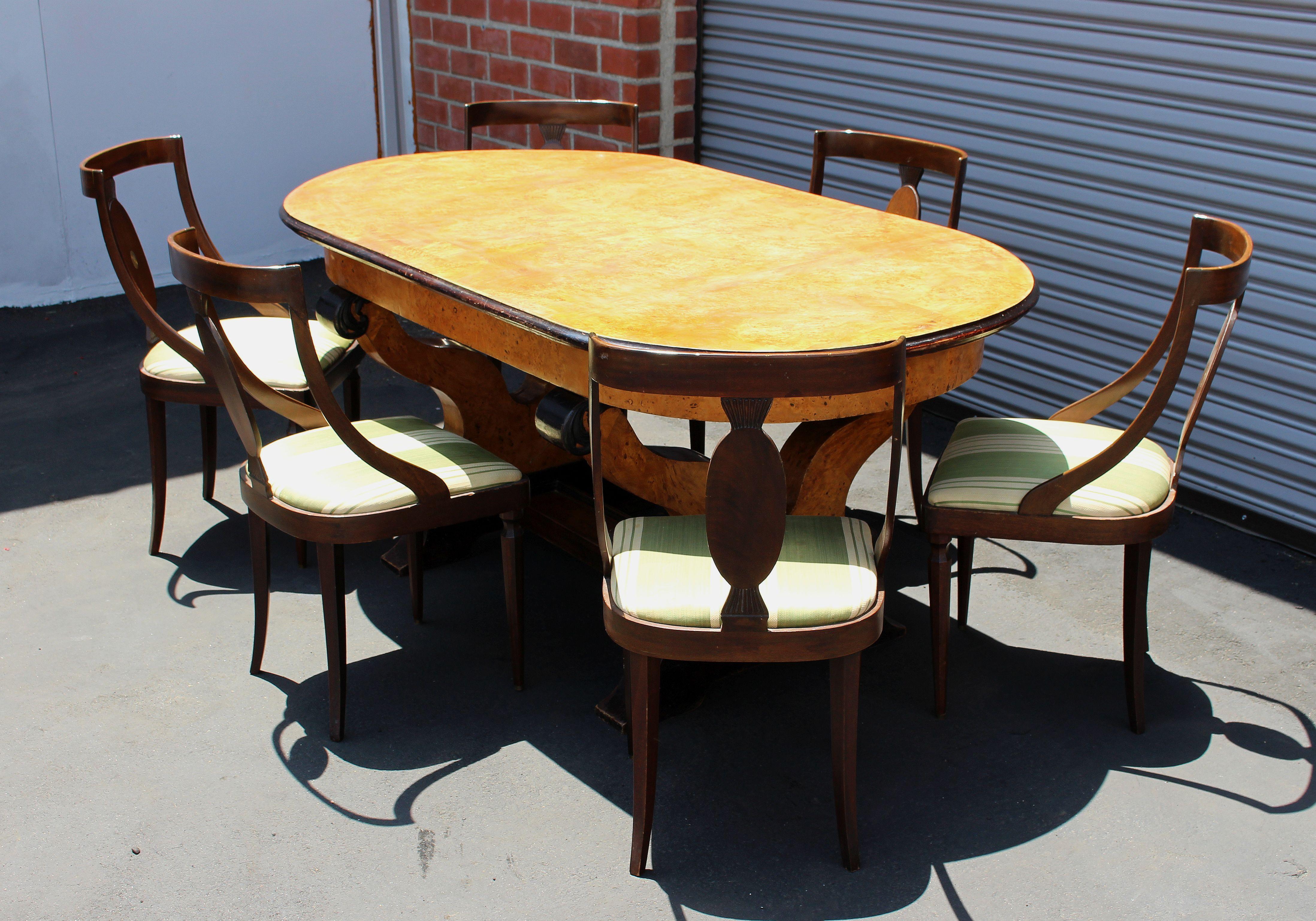 Table and six chairs set, burl maple veneer top and walnut base. Chairs reupholstered in original material from the period some of the upholstery have the spots I believe it can clean very good .Tabletop can be dismantle for easy transport. 
