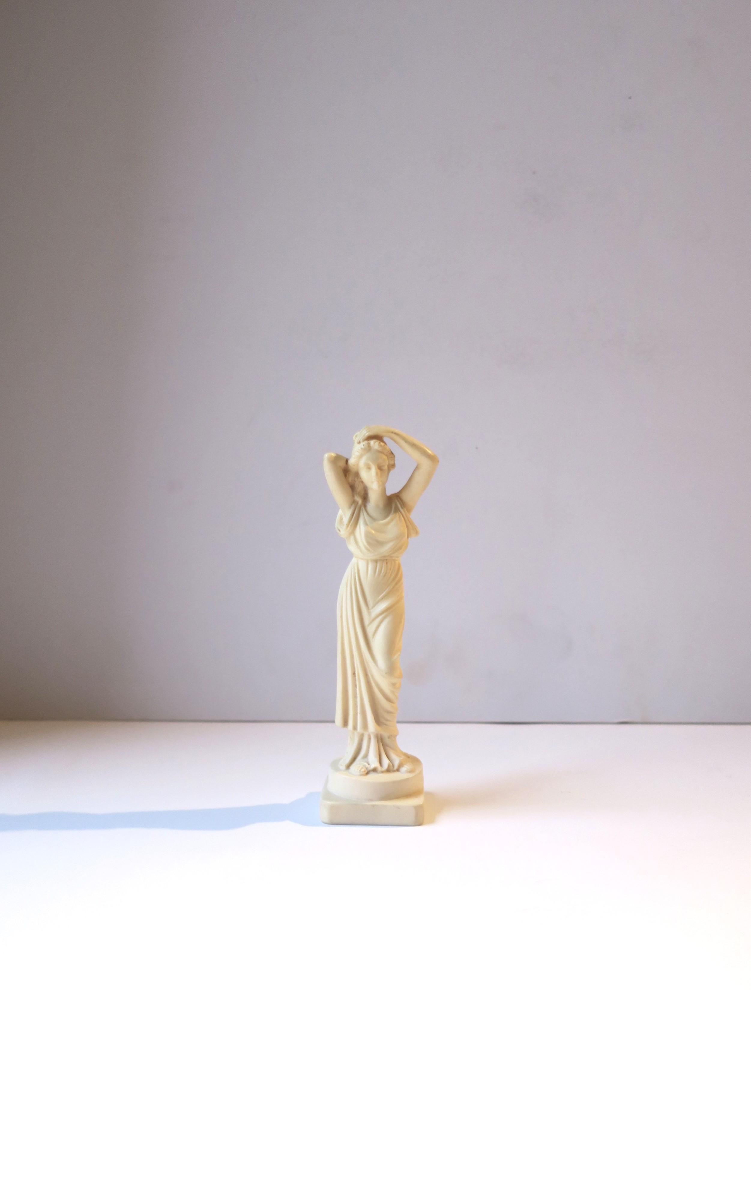 An Italian female resign sculpture statue in the Neoclassical design style, circa mid-20th century, 1950s, Italy. Sculpture statue is an off-white resin. A great decorative object. Marked 'Made in Italy' on bottom as shown in last image. Dimensions: