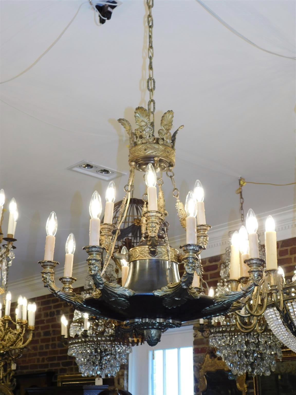 Italian Neoclassical gilt bronze figural chandelier with central bulbous ornamental foliage finial, twelve upward scrolled acanthus arms, shell form floral filigree canopy, decorative foliage medallion chains, and terminating with an ornamental