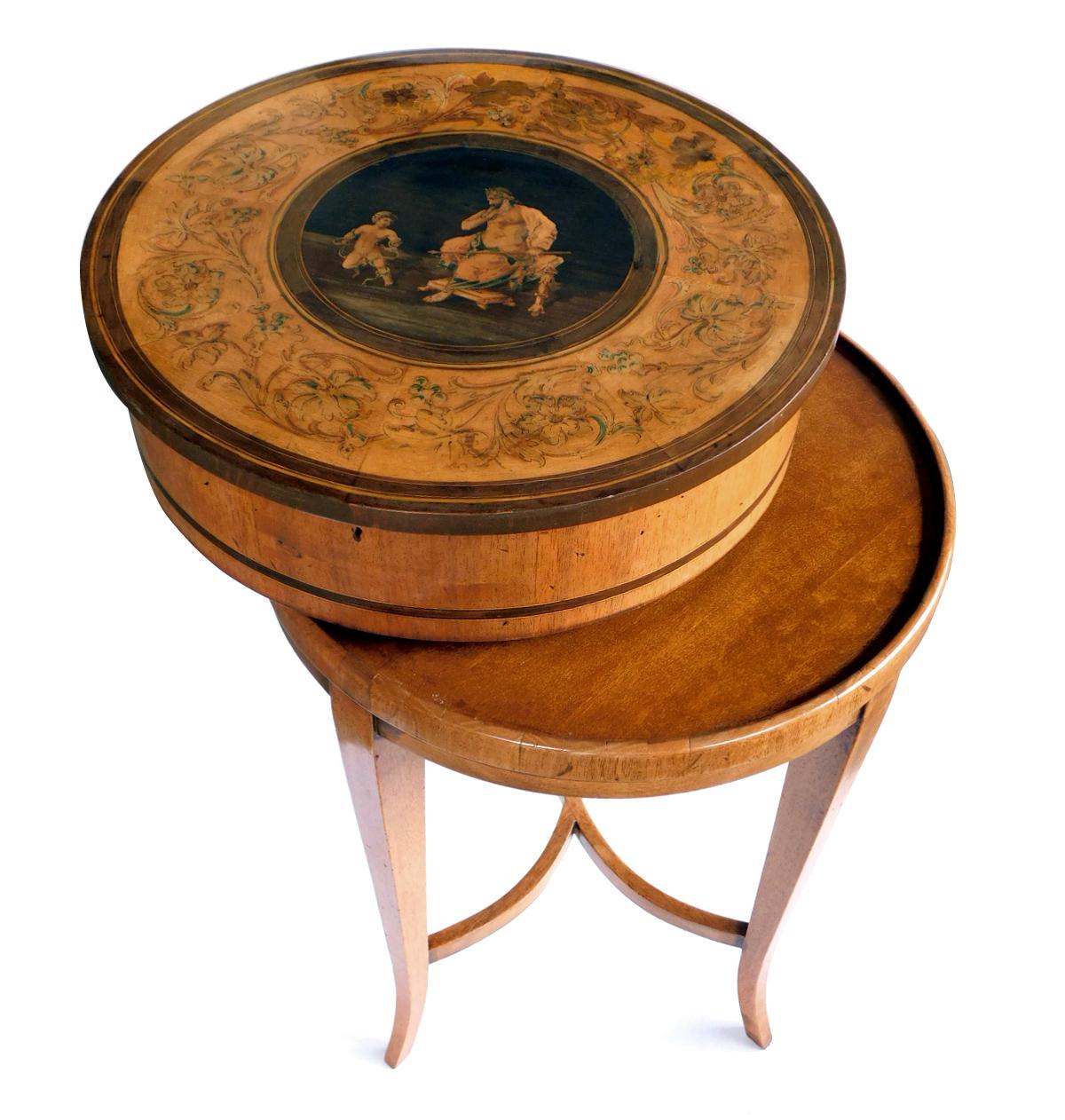 The circular hinged top with scrolling Florentine-style inlaid acanthus leaf and floral band; surrounding an ebonized roundel centering an Italianate figure of a Roman god and putto; with Antonio's antiques retail tags.