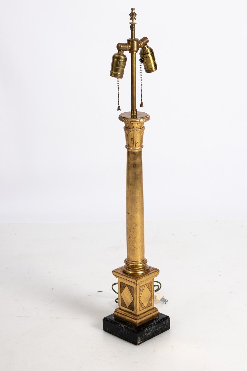 Gilded column lamp on faux marble base, circa 1920s. Please note of wear consistent with age including minor wear to gilding along with small chips and cracks at joints but structurally sound. Shade not included. Made in Italy.
