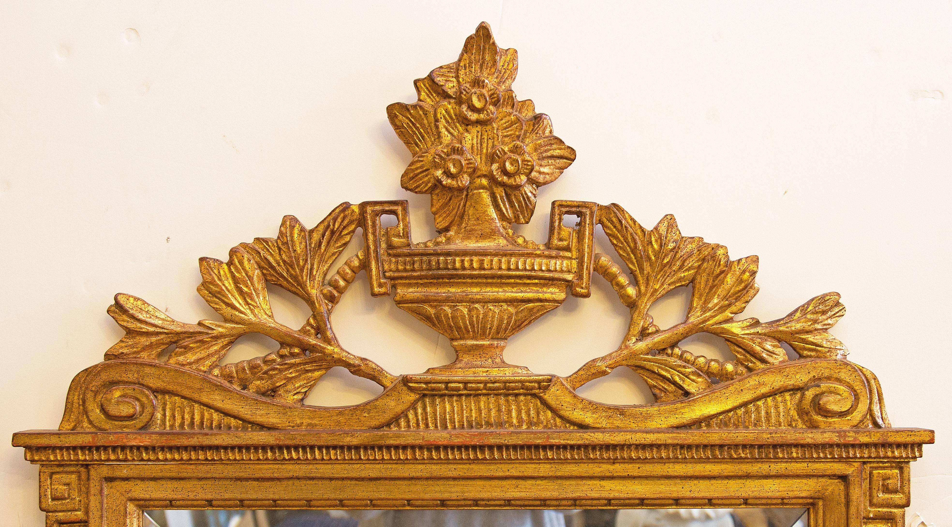 Neoclassical gold gilt and carved wood console mirror. Made in Italy. Mid-20th century. Mirror is beveled glass.
  