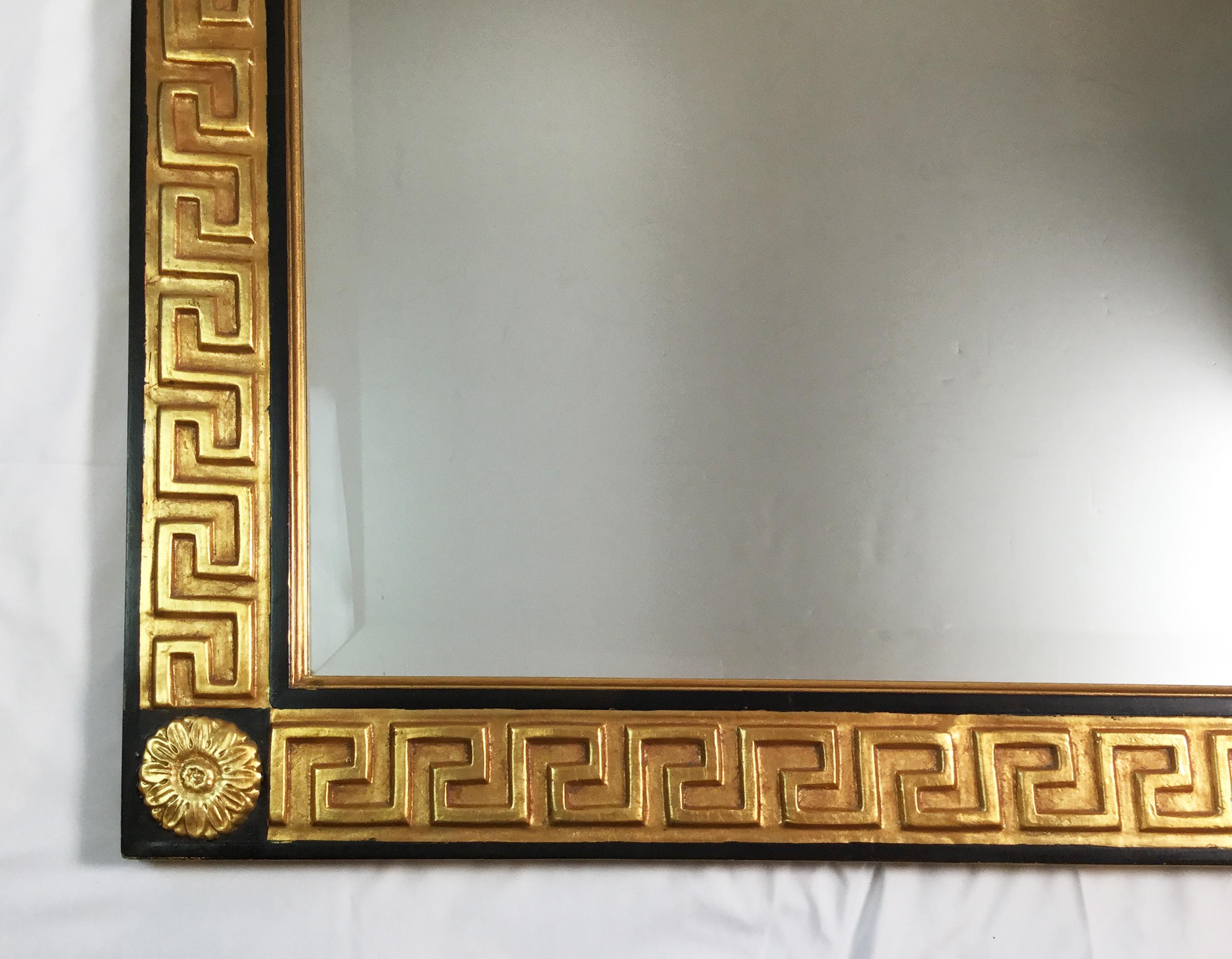 Rectangular gold and black beveled mirror with neoclassical Greek key frame. Can be hung vertically or horizontally.
