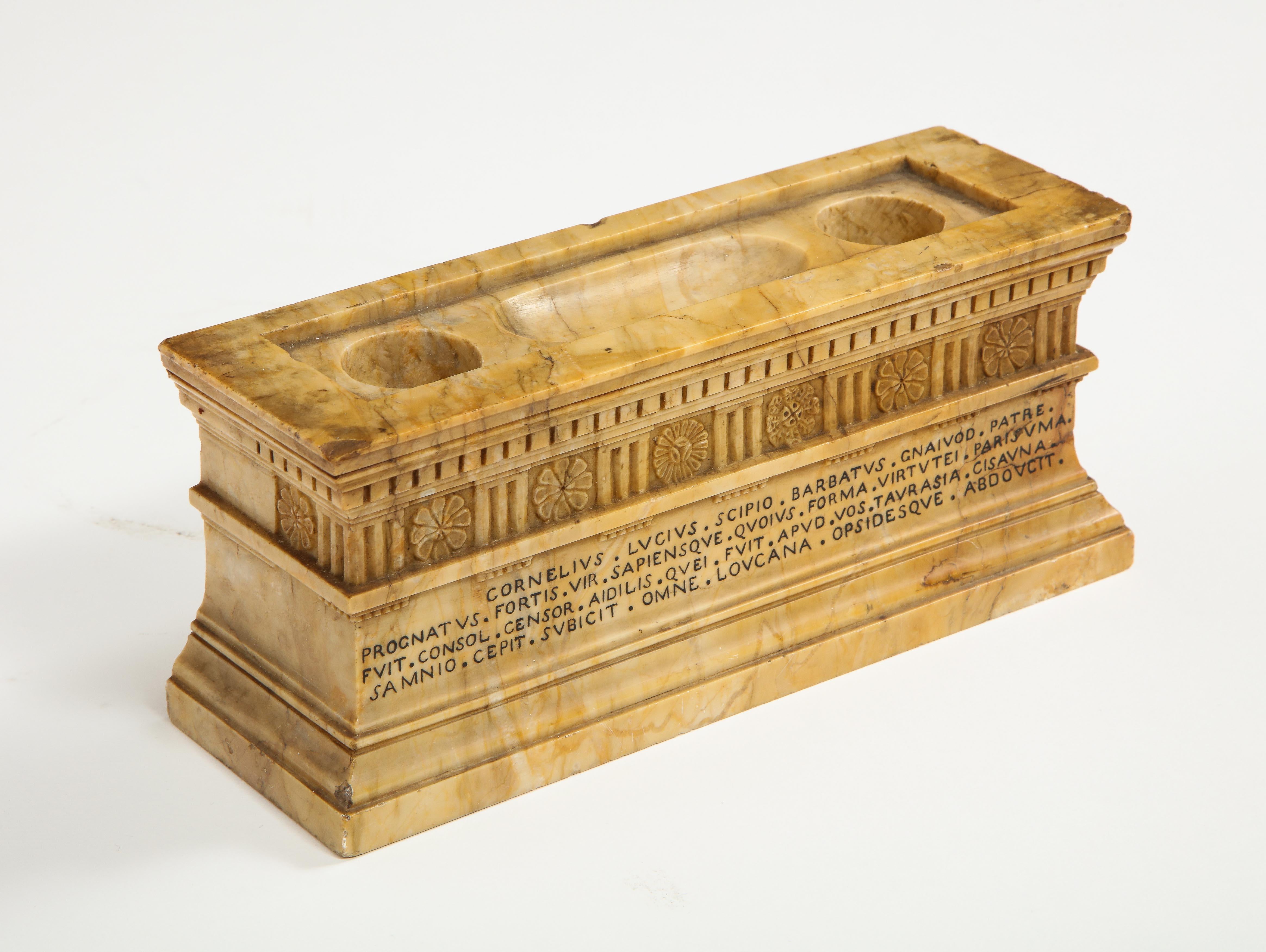 A  19th century Italian Grand Tour model of the tomb of Roman consul Lucius Cornelius Scipios Barbatus, the sarcophagus of rectangular form in carved sienna marble.

Incised inscription reading: