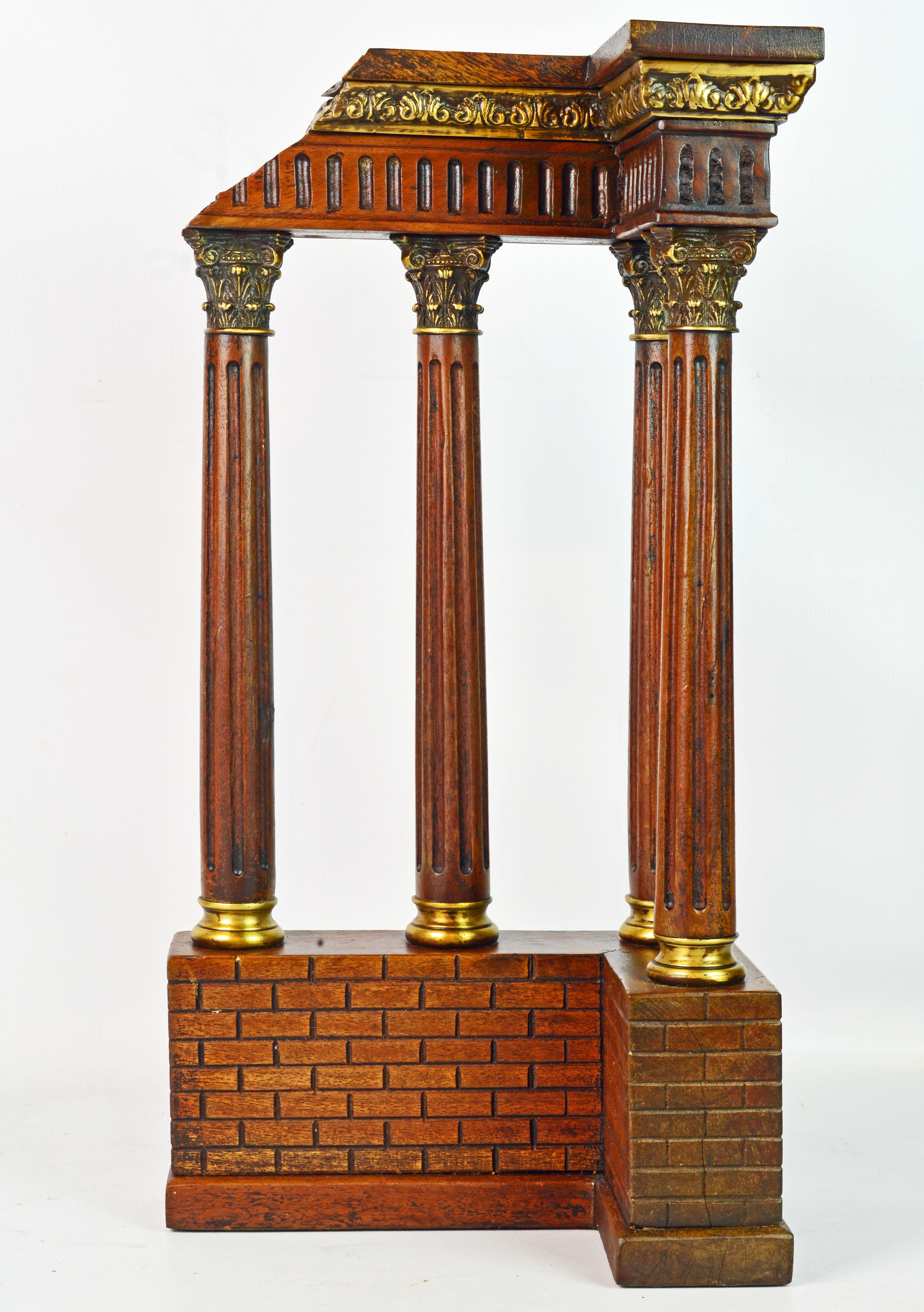 Standing 20.5 inches tall this Italian model of a temple fragment or ruin features a corner with four fluted Corinthian columns with bronze capitals and bases carrying an epistyle under a modeled bronze frieze. The columns rest on a simulated