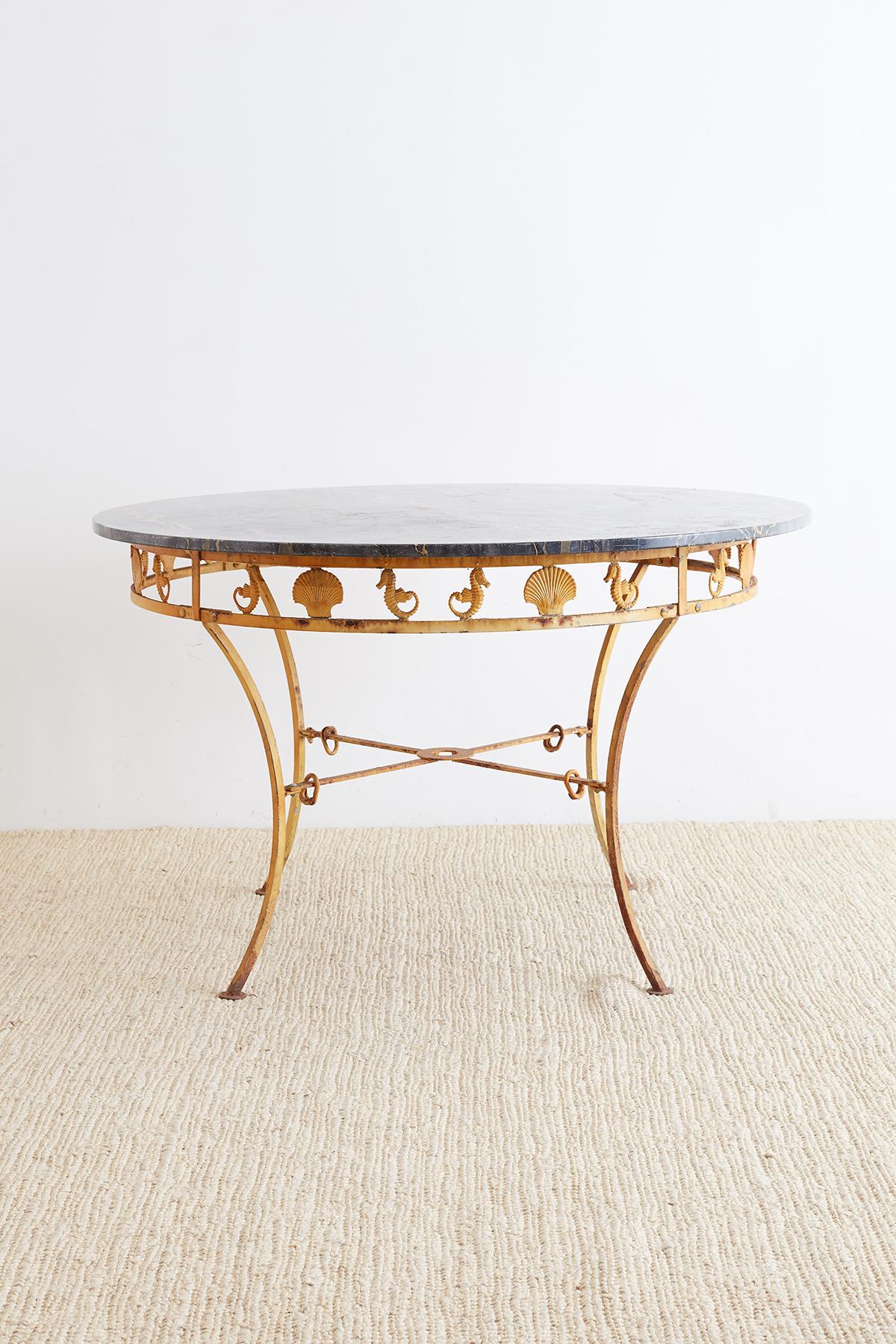 Captivating Mid-century marble garden patio dining table by Molla. Featuring a neoclassical style iron base decorated with their sea horses and shell motif design on the sides. Constructed from cast aluminium and supported by curved legs ending with