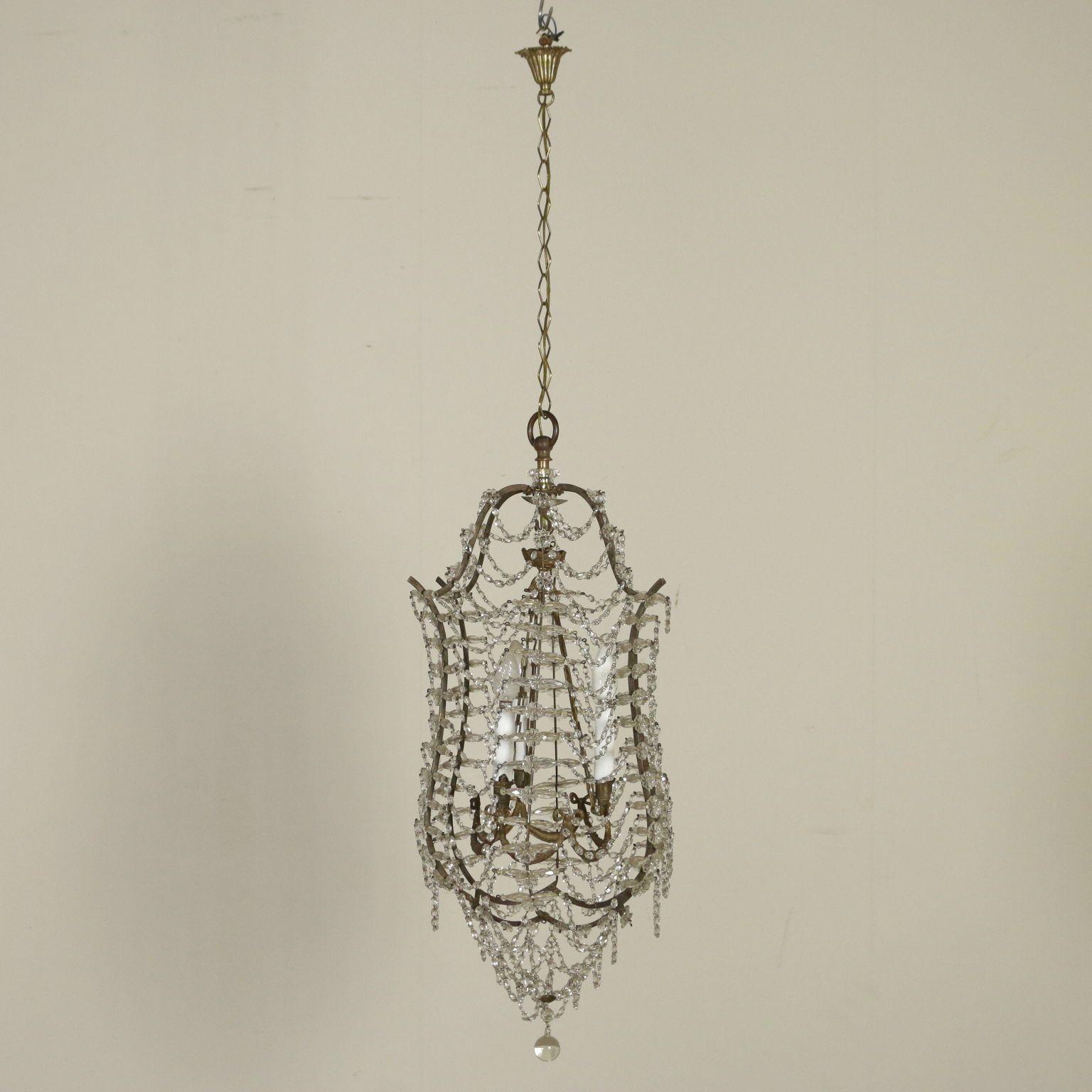 Scrolling cage form centered by three arms, hung with beaded drapes and facet cut prism.