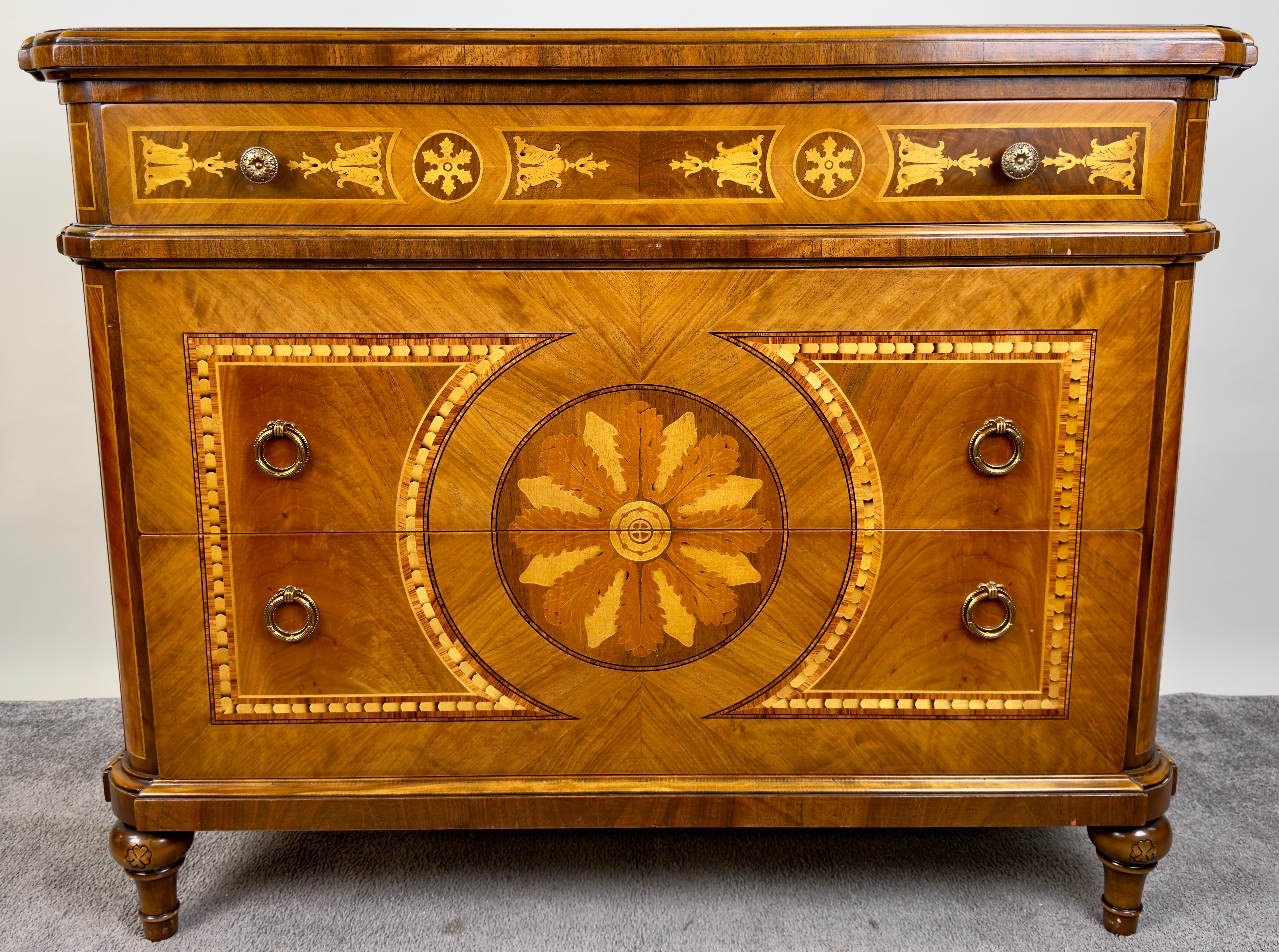 Un italiano neoclásico  caoba  Arcón o cómoda de tres cajones, caracterizado por su exquisita artesanía y elaborada marquetería. La parte delantera presenta intrincadas incrustaciones, con un motivo floral central rodeado de motivos geométricos. La