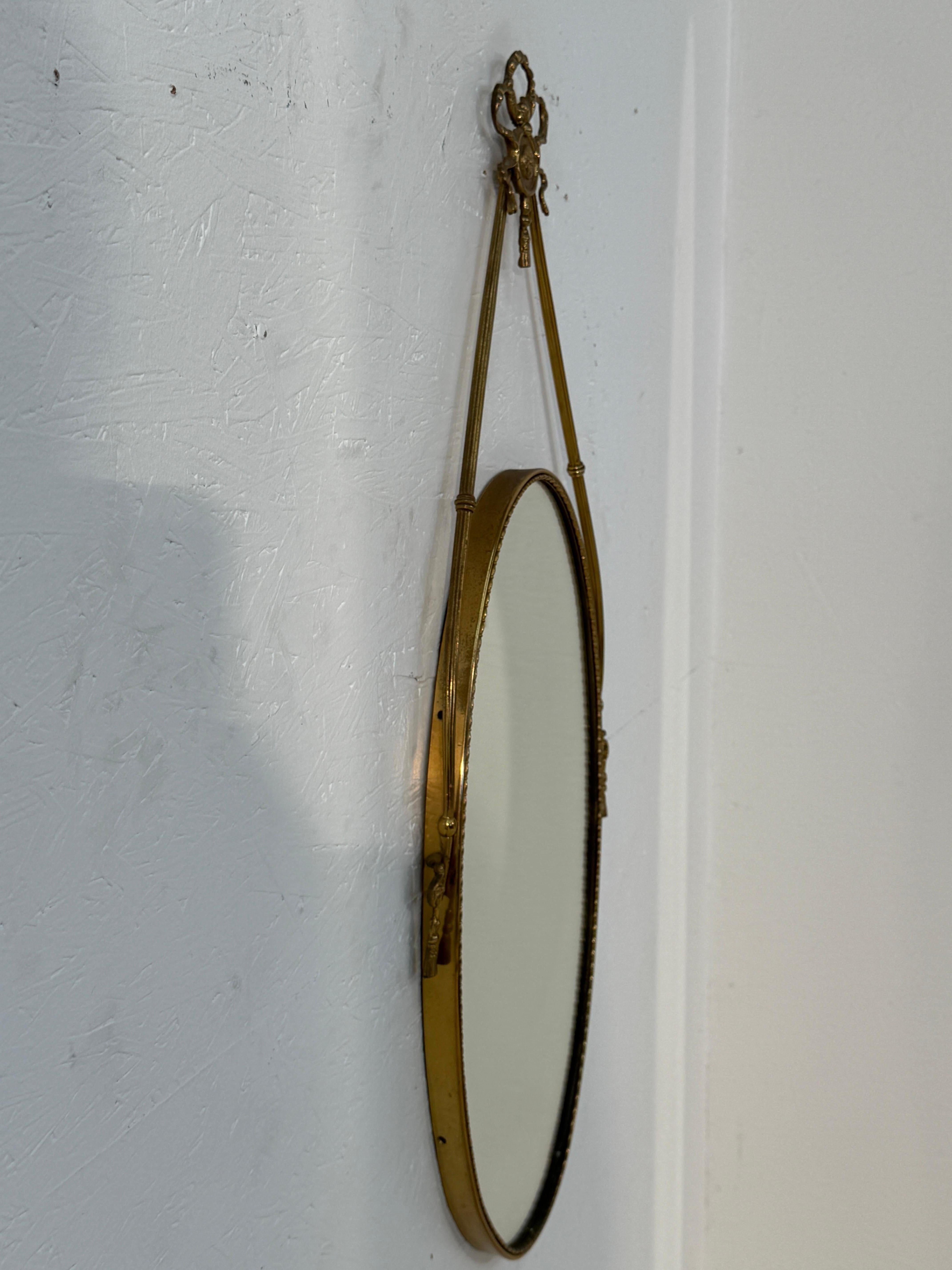 Metà XX secolo Italian Neoclassical Oval Mirror with Brass Ribbon and Tassel Detailing, 1950s in vendita