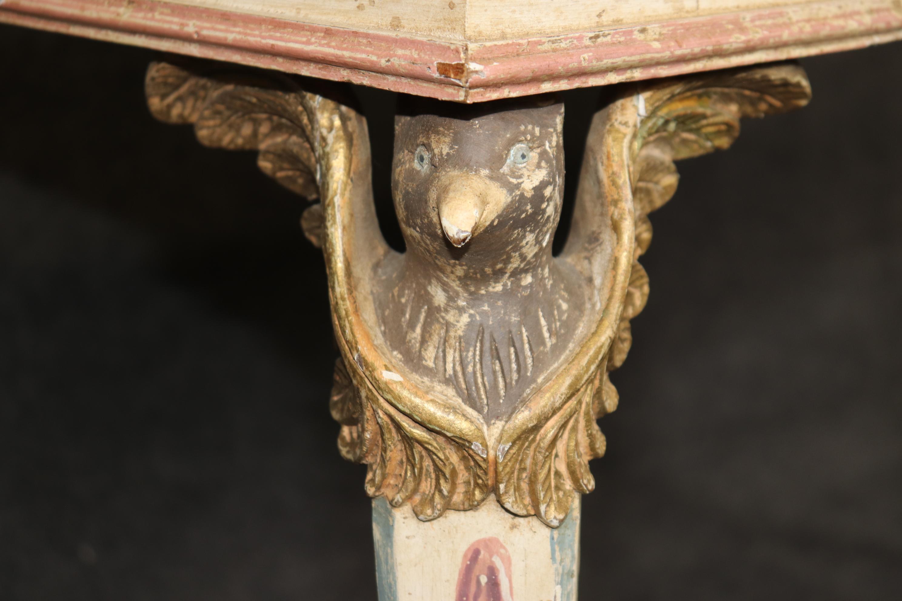 This is a gorgeous and very unique Italian table. Teh table features all of the expected neoclassical elements. Paint of a noble Roman, carved eagle terminals on top of the front legs, and gorgeous Verdi green marble on top. The table is lovingly