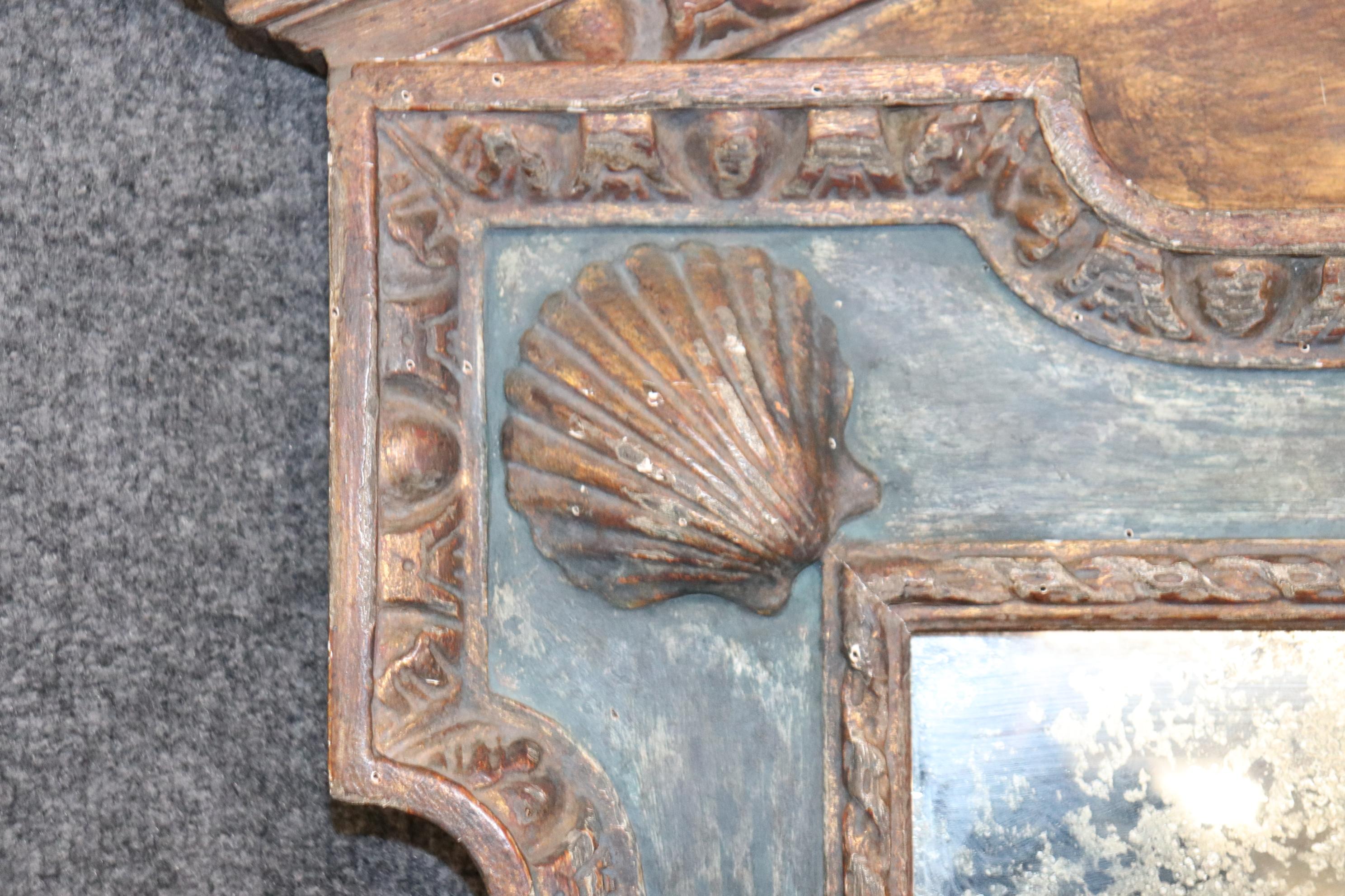 This is a fantastic mirror made in Italy that almost looks Federal, however we need to remeber that Federal designs were fashioned after Greco-Roman styling from several thousand years ago. The mirror features seashells carved at each corner and a