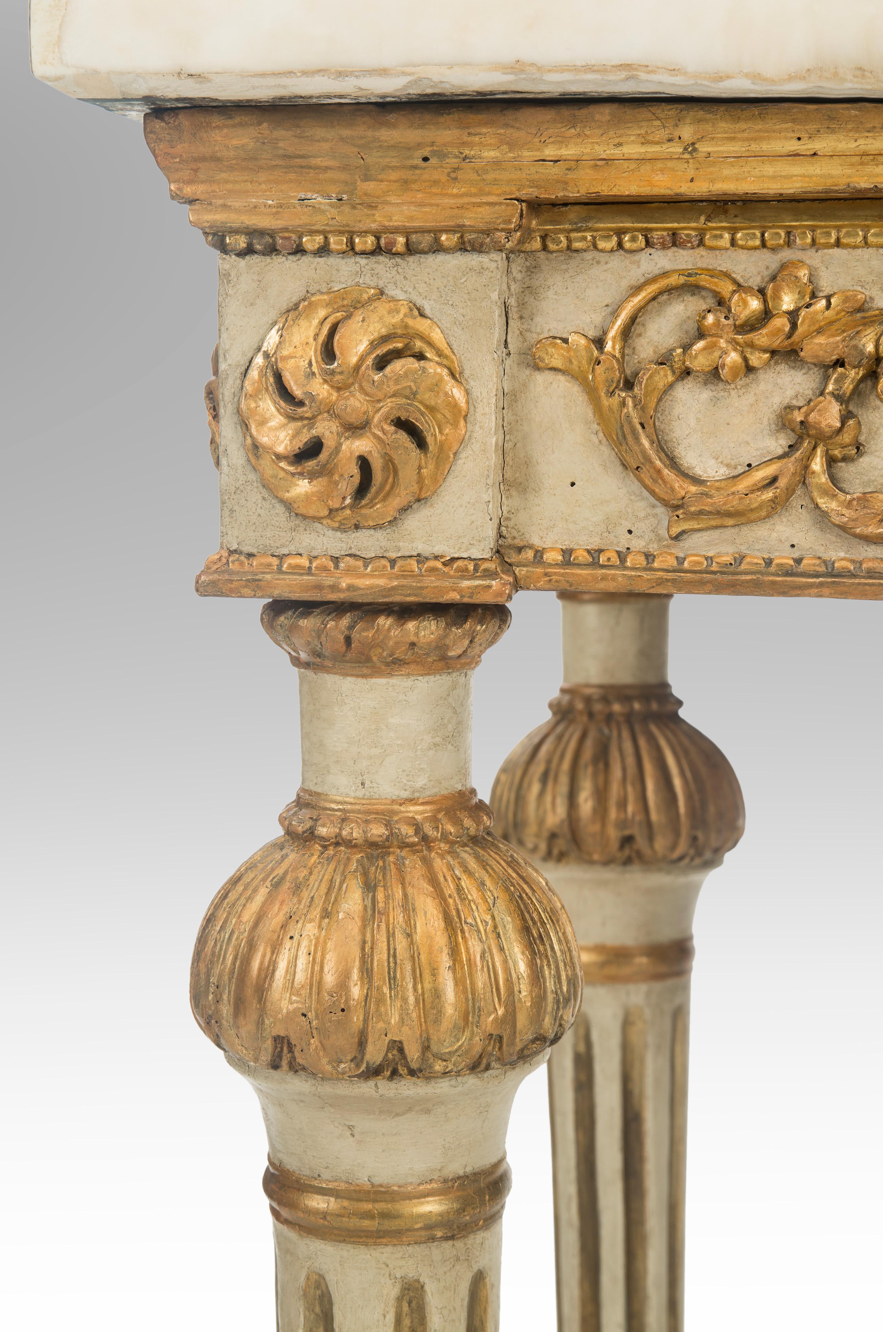 Italian neoclassical painted and parcel-gilt console table
Late 18th century
A handsome neoclassical-period console table with lively carvings. The beautiful Siena marble top with a Carrara marble border, above an apron centered by a laurel wreath