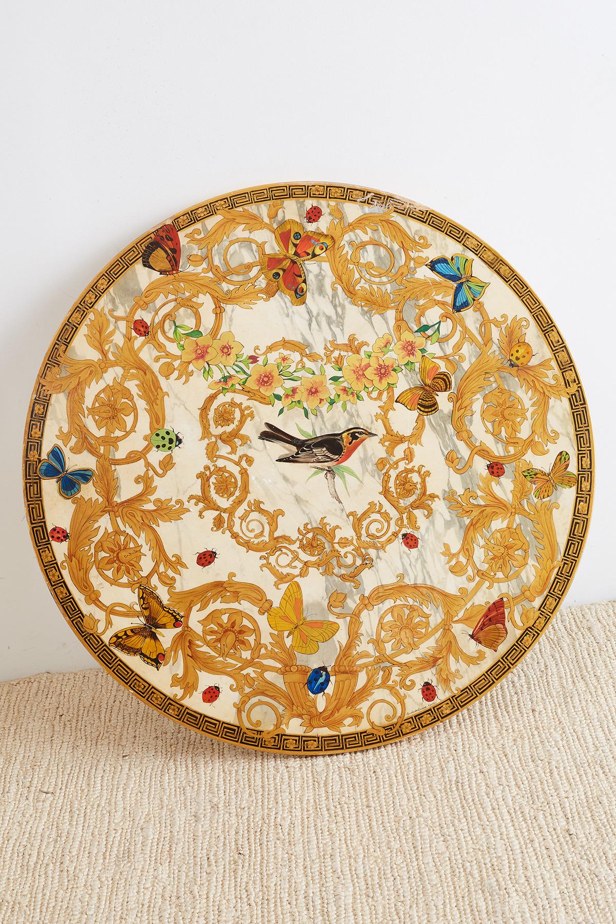 Spectacular Italian painted parcel-gilt marble-top center table featuring a carved tripod base with cherub faces. Made in the neoclassical taste the white marble top is decorated with ladybugs and butterflies centered with a robin. The flora and