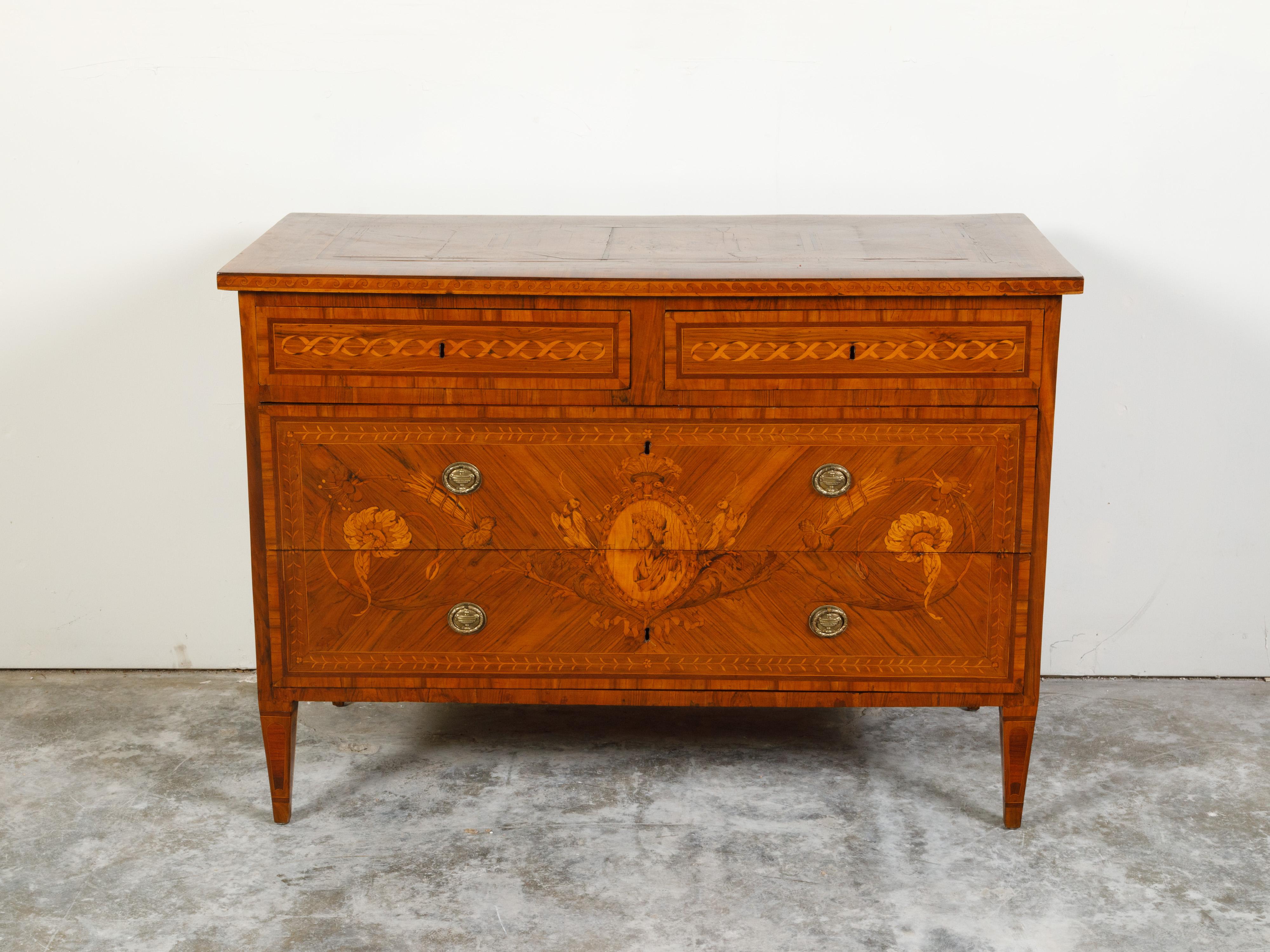An Italian neoclassical period fruitwood commode from the early 19th century, with four drawers and marquetry décor. Created in Italy during the early years of the 19th century, this neoclassical chest features a rectangular top with marquetry décor