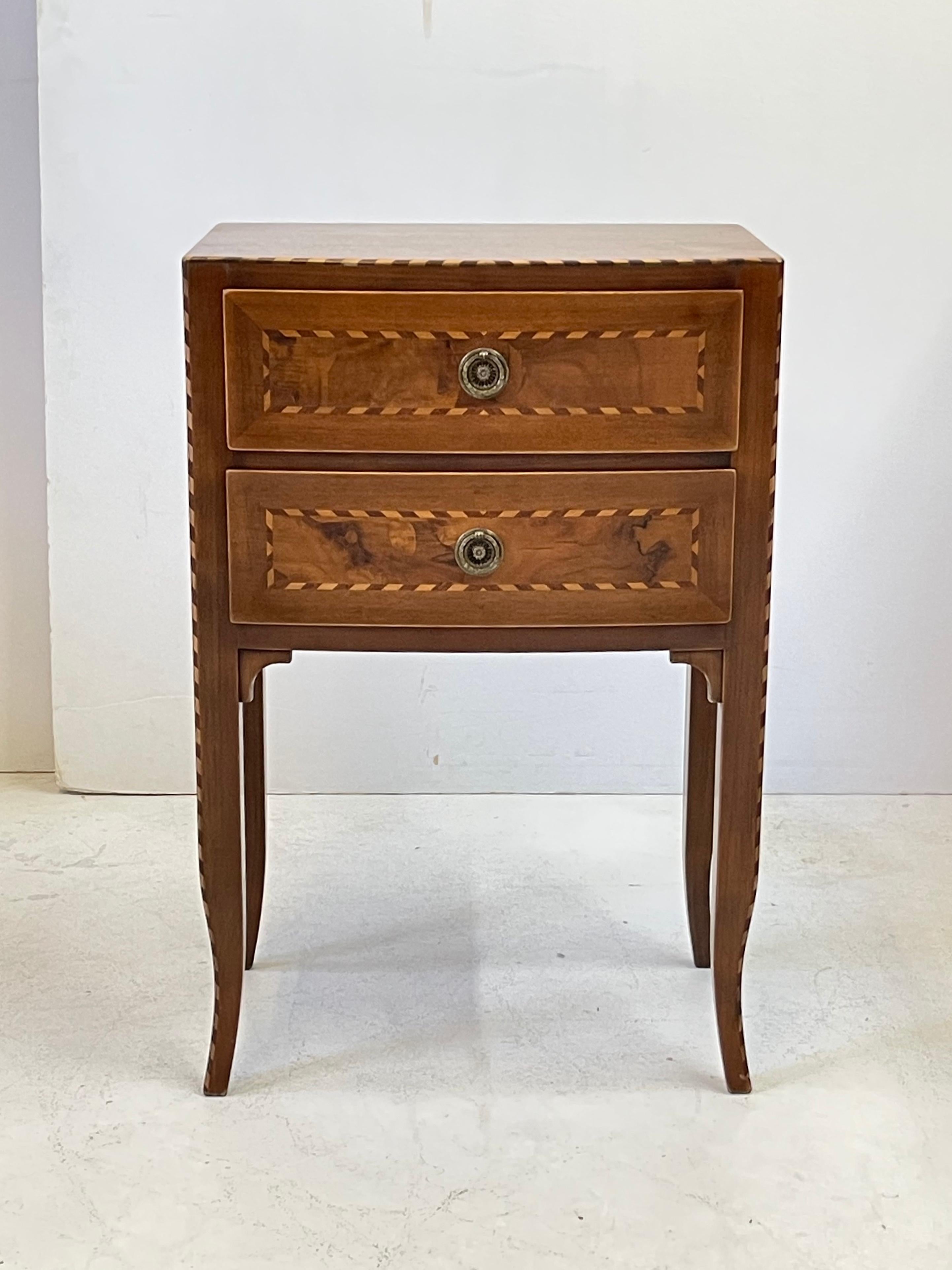 Early 20th Century Italian side table of exceptional craftsmanship having a walnut bow-front case trimmed with banded inlay and holding two drawers. The drawer fronts are beautifully decorated with inset burl walnut panels outlined by cross banded