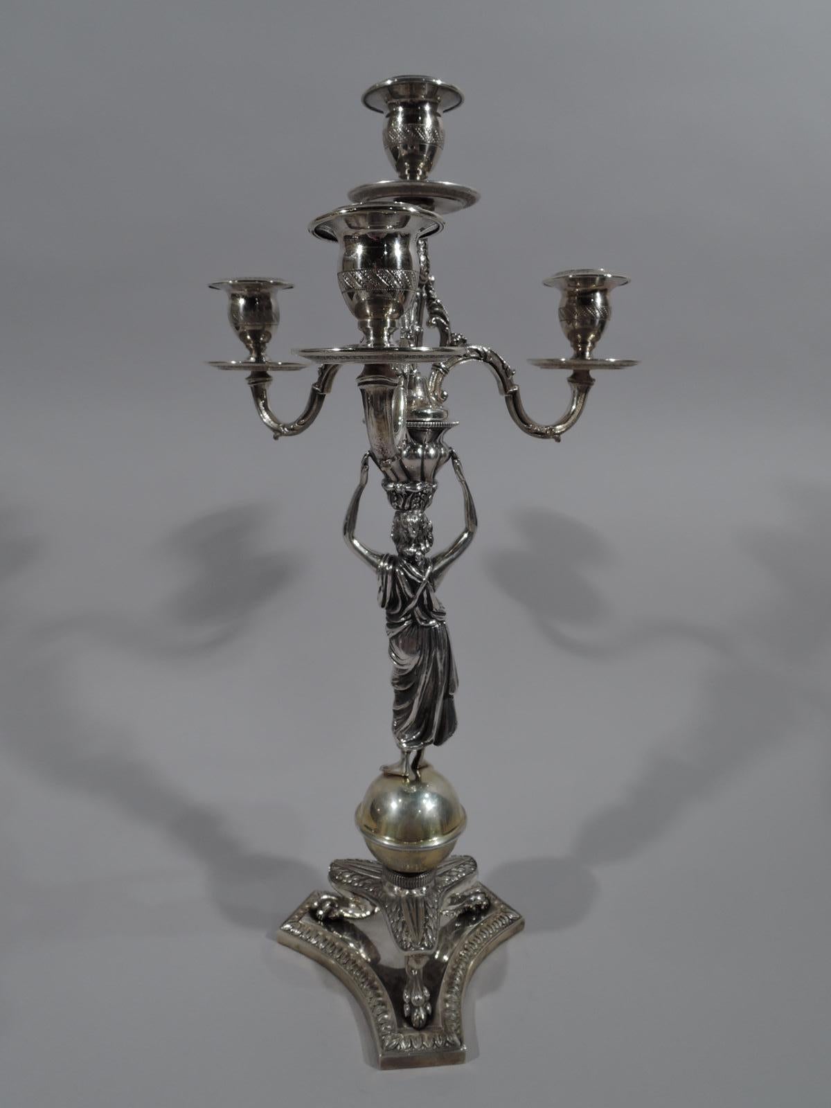 Neoclassical 800 silver 4-light candelabrum. Figural shaft in form of draped Classical bare-breasted, barefoot woman. Her raised arms support on her head a basket with threaded branches: Central light on leaf-decorated shaft to which are mounted