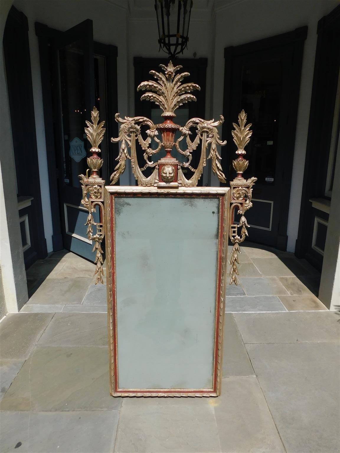 Italian neoclassical silver gilt wood & gesso red lacquered wall mirror with a central urn lion mask cartouche decorated with scrolled foliate plumes and ribbon drapery, flanking foliate urns with graduated bell flowers, and a floral carved exterior