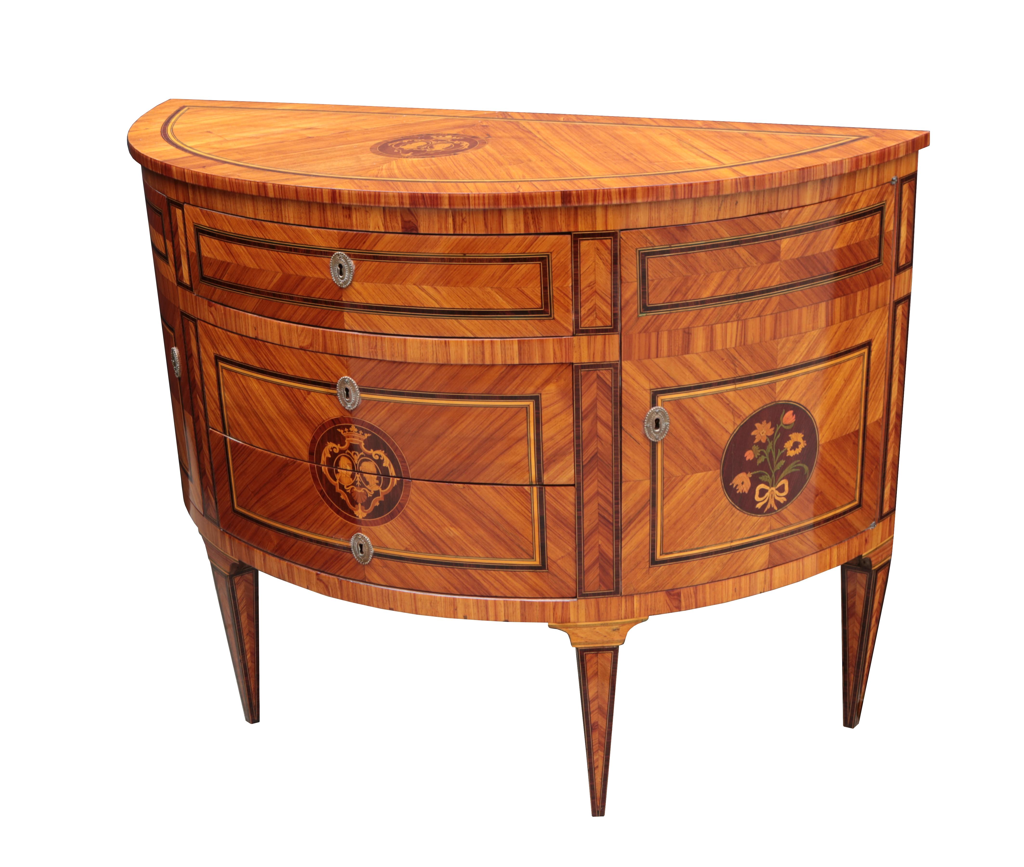 A Neoclassical Demi-Lune chest.

Various woods in marquetry patterns with fine fruitwood inlay details

and patinated brass escutcheons .

Three center drawers flanked by side cabinets.