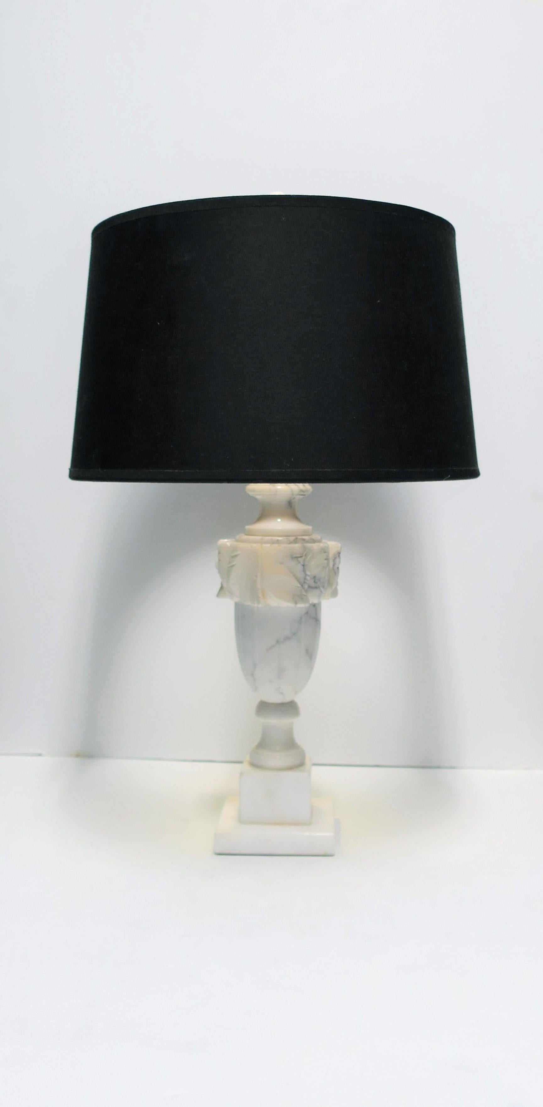 A beautiful, predominantly white, Italian neoclassical style urn form carved solid Carrara marble table or desk lamp, circa early 20th century, Italy. Marble (Carrara marble) is predominantly white with black and gray veining throughout. Includes