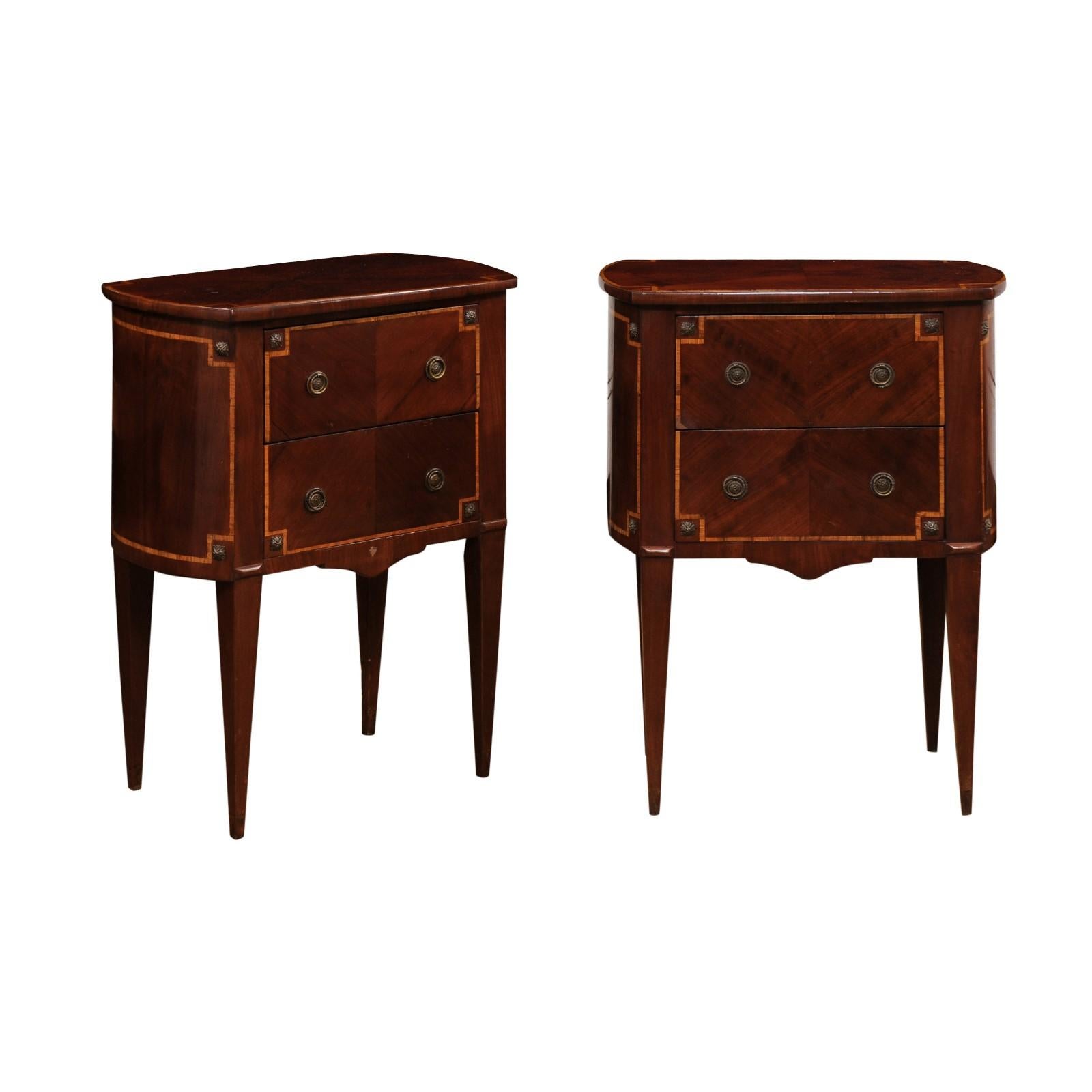 Pair of Italian Neoclassical style mahogany and birch bedside tables from the 19th century with bookmatched veneer. Immerse yourself in the allure of Italian craftsmanship with this 19th century pair of Neoclassical style bedside tables. The tables