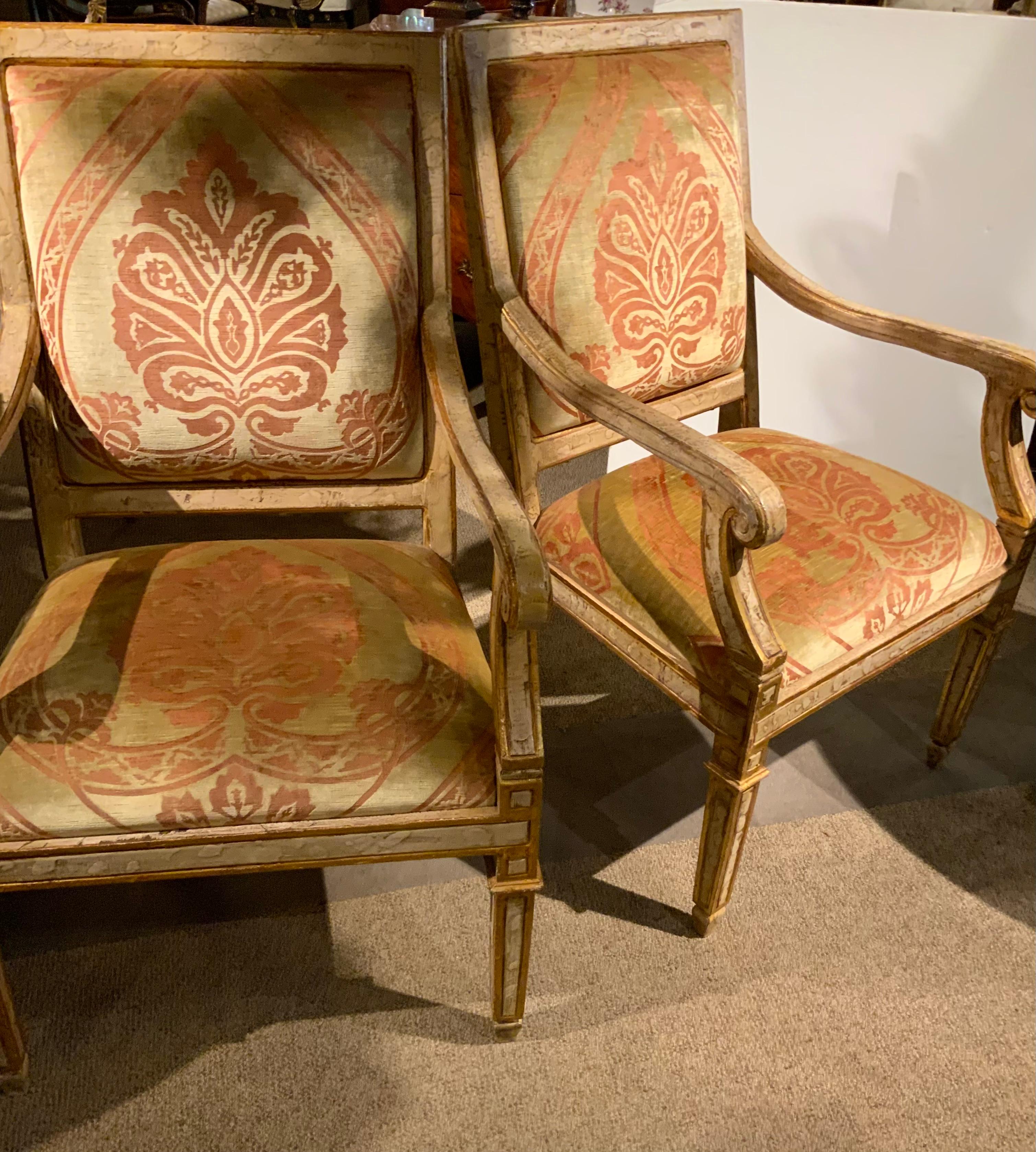 The unique painted finish with a touch of gild makes this pair
Special. The rectangular back with hand carved molding and
Inset upholstered back transitions into gracefully sloping arms
With robust scroll handles; a gentle forward sweep to a
