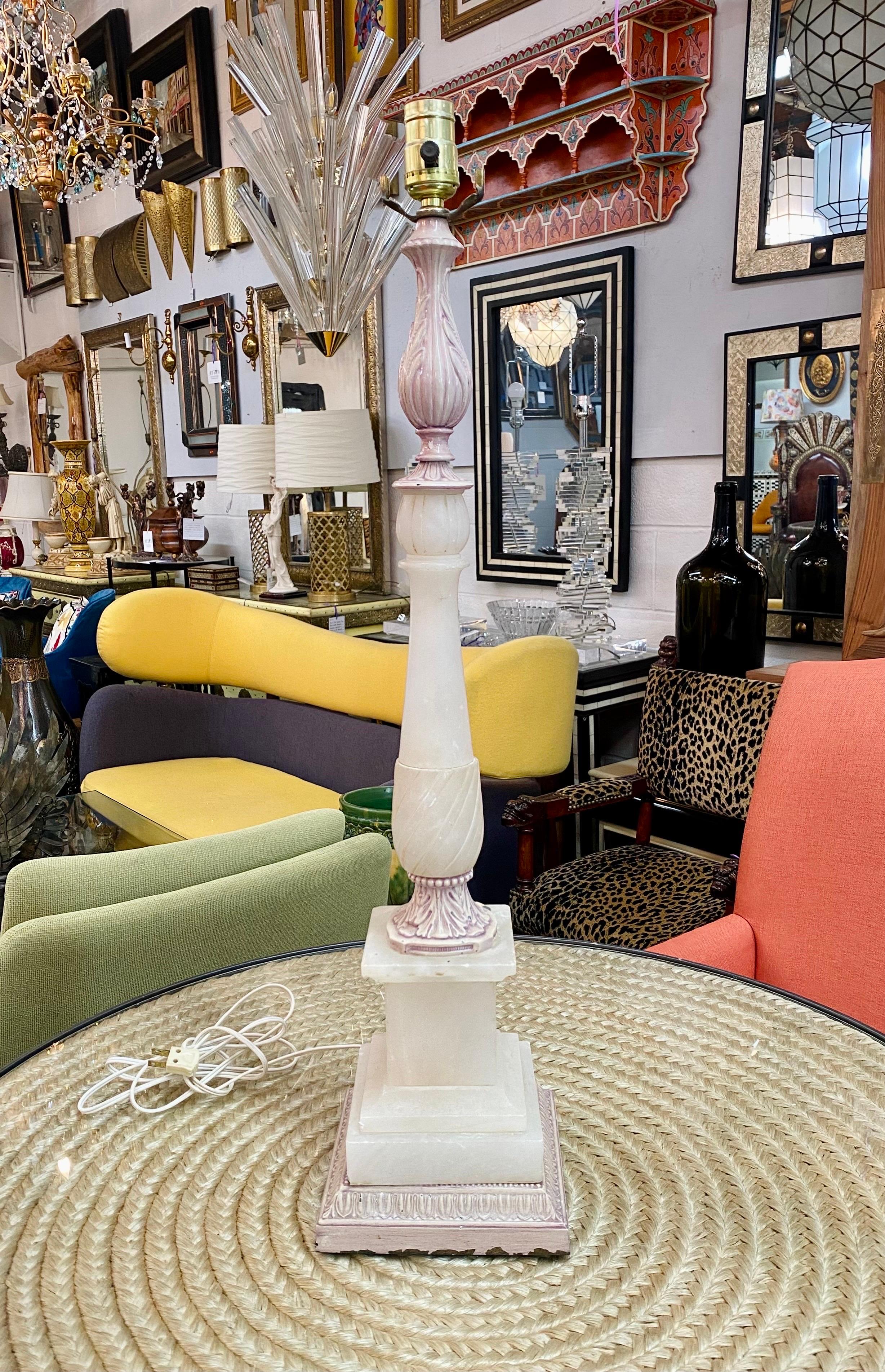 An elegant pair of Italian Neoclassical style table lamps made of hight quality alabaster. The Mid- century made table lamps have a beautiful carved columns showing curvy shapes adding to its charm and style . The 4 dimensional square base also